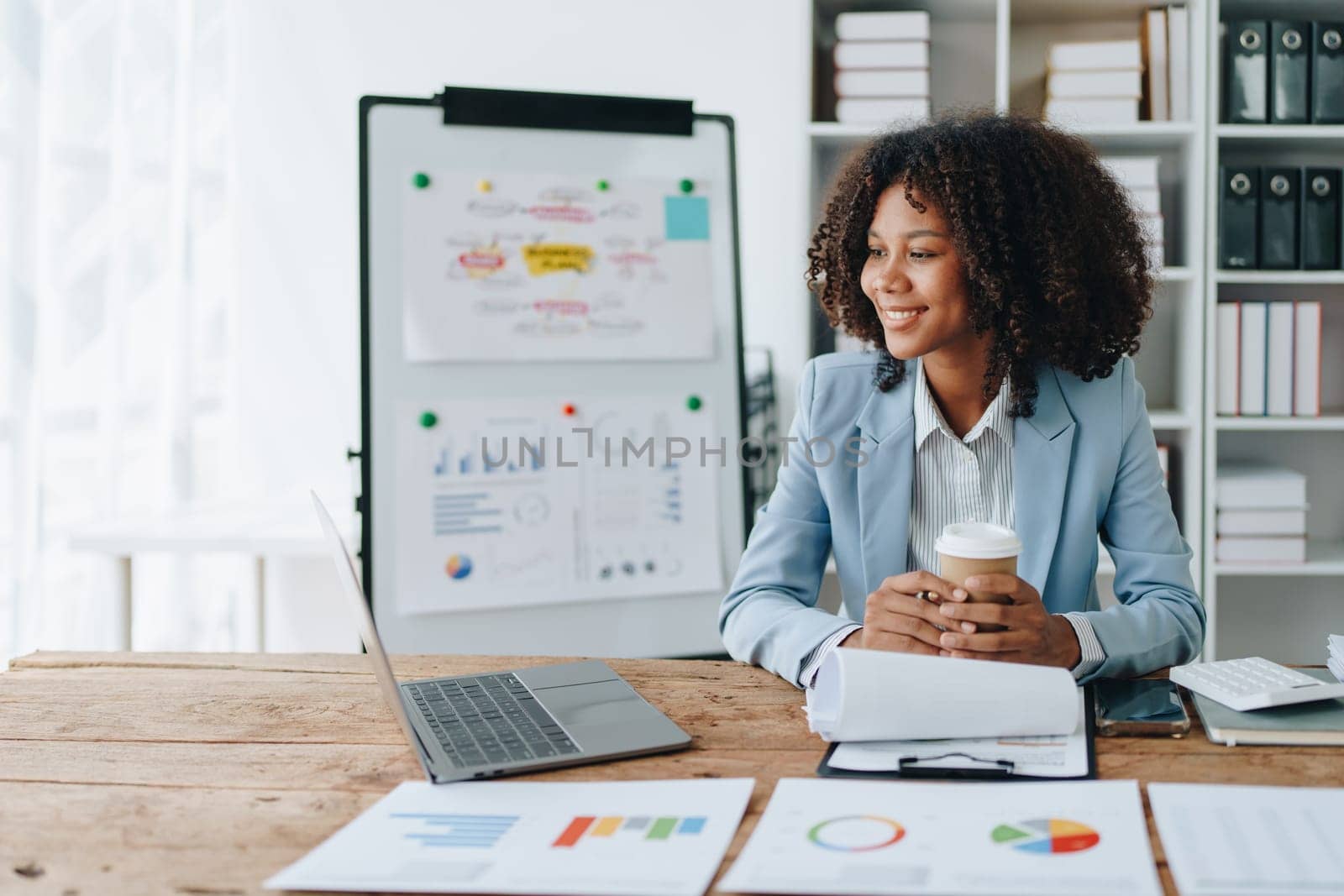 American African business woman using document, computer laptop, calculator, paperwork, documents, in winner and smiling Happy to be successful achievement success. finance and investment concepts.