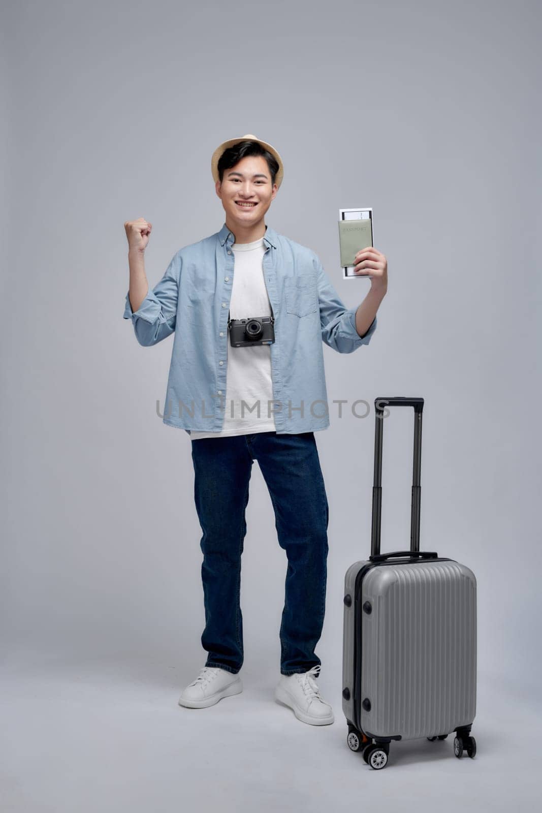 Full size photo of young man happy positive smile travel abroad isolated over white background