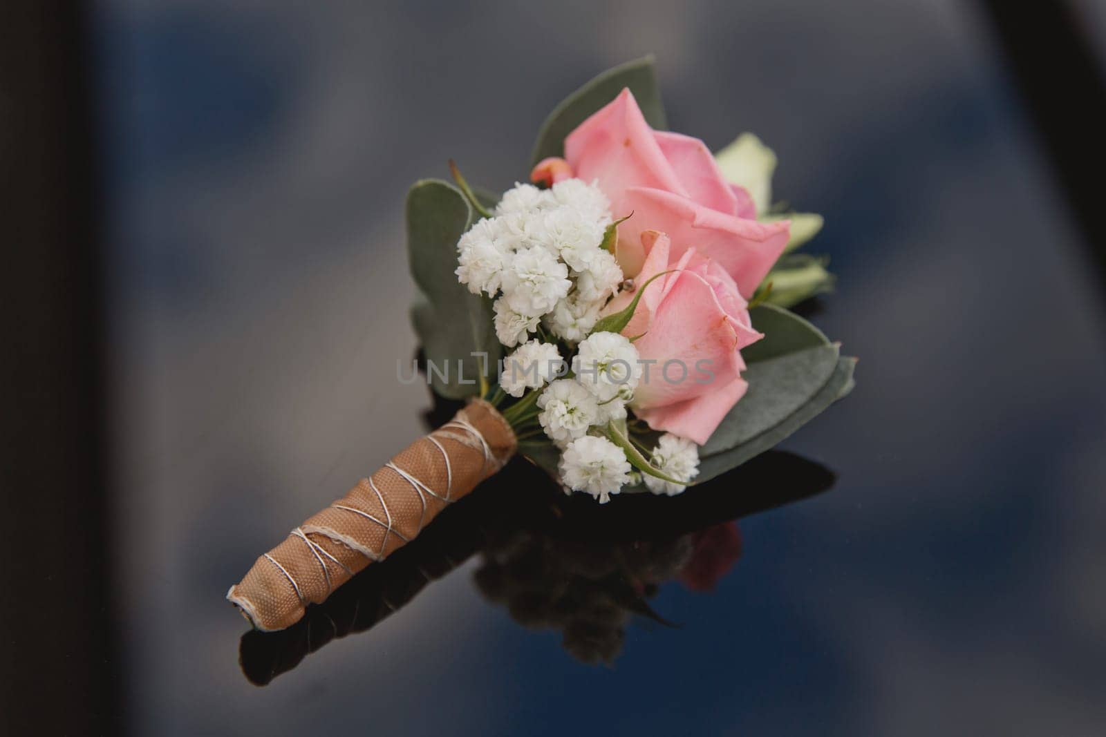 Elegant wedding boutonniere with fresh flowers. Soft focus.