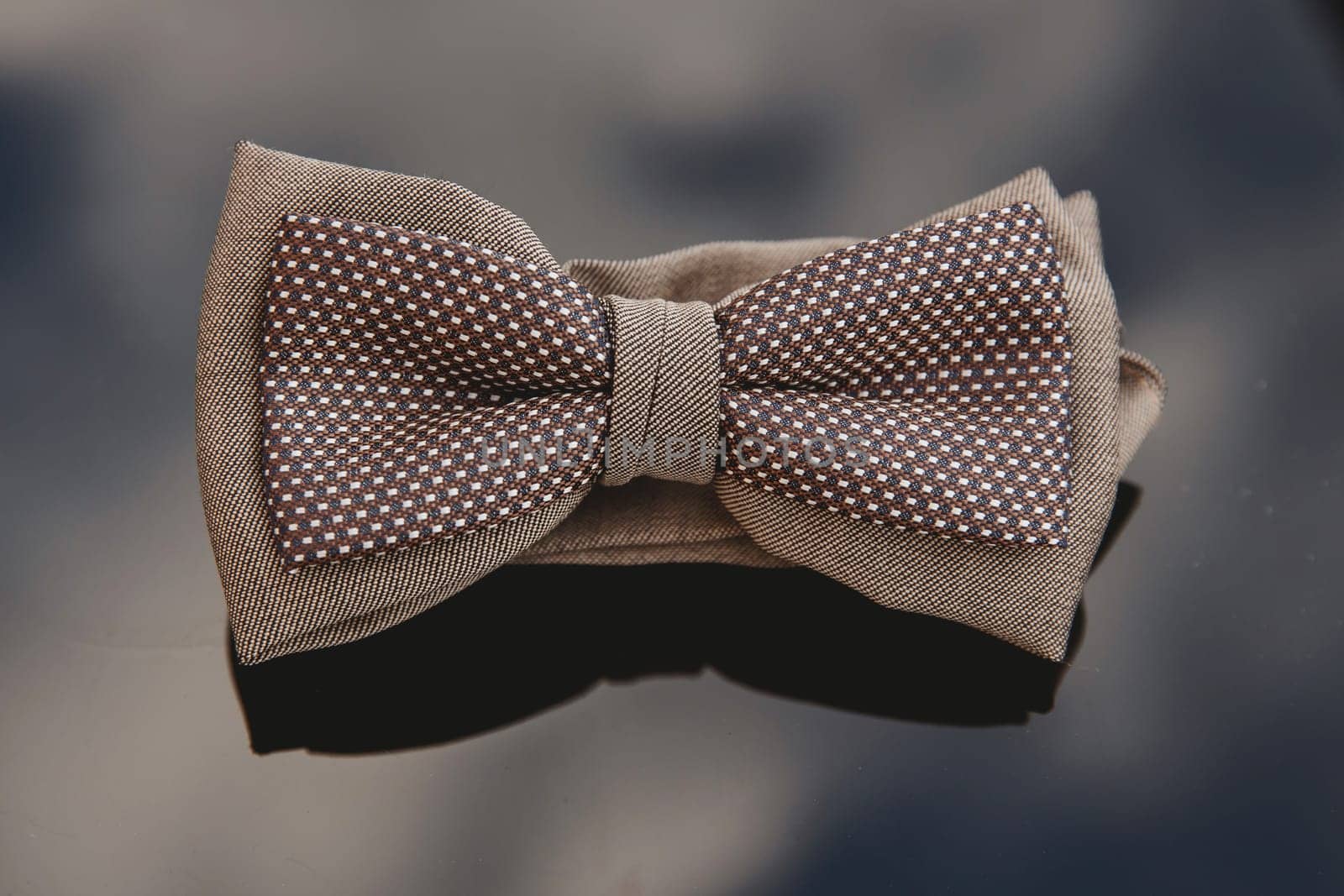 Men's bow tie on a mirror background. Close-up.