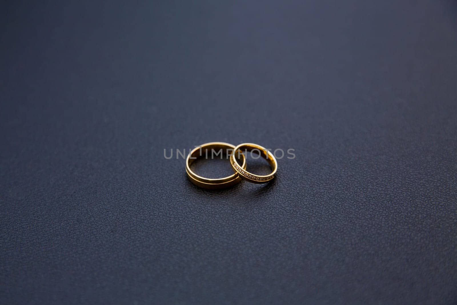 Golden wedding rings on the table. Soft focus.