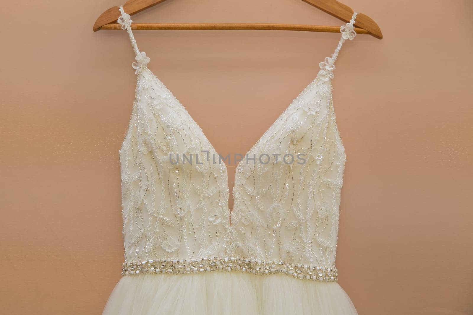 The delicate bride's dress is hanging in room. Selective focus. Close-up. by leonik