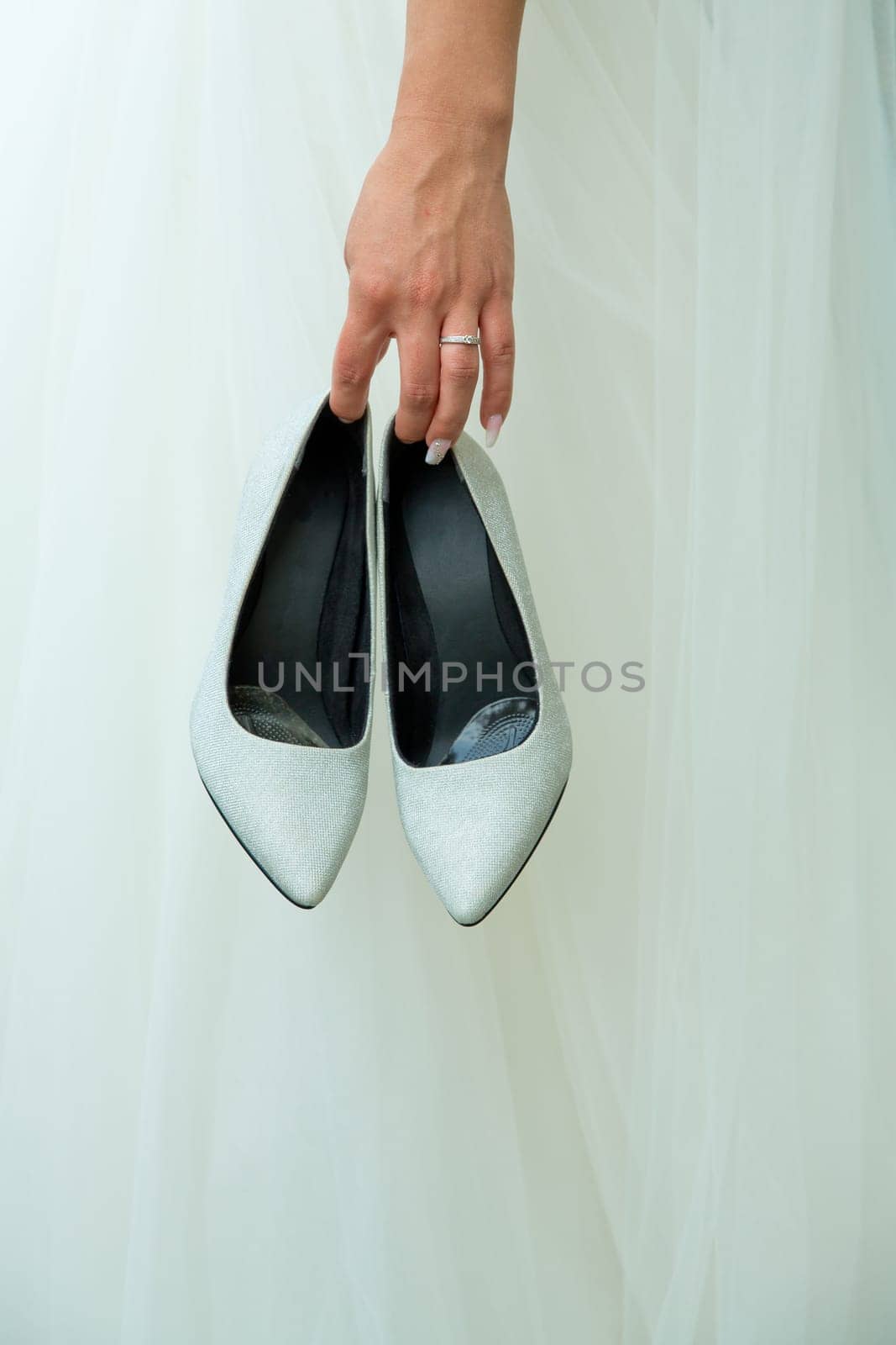The bride holds wedding shoes in her hands. by leonik