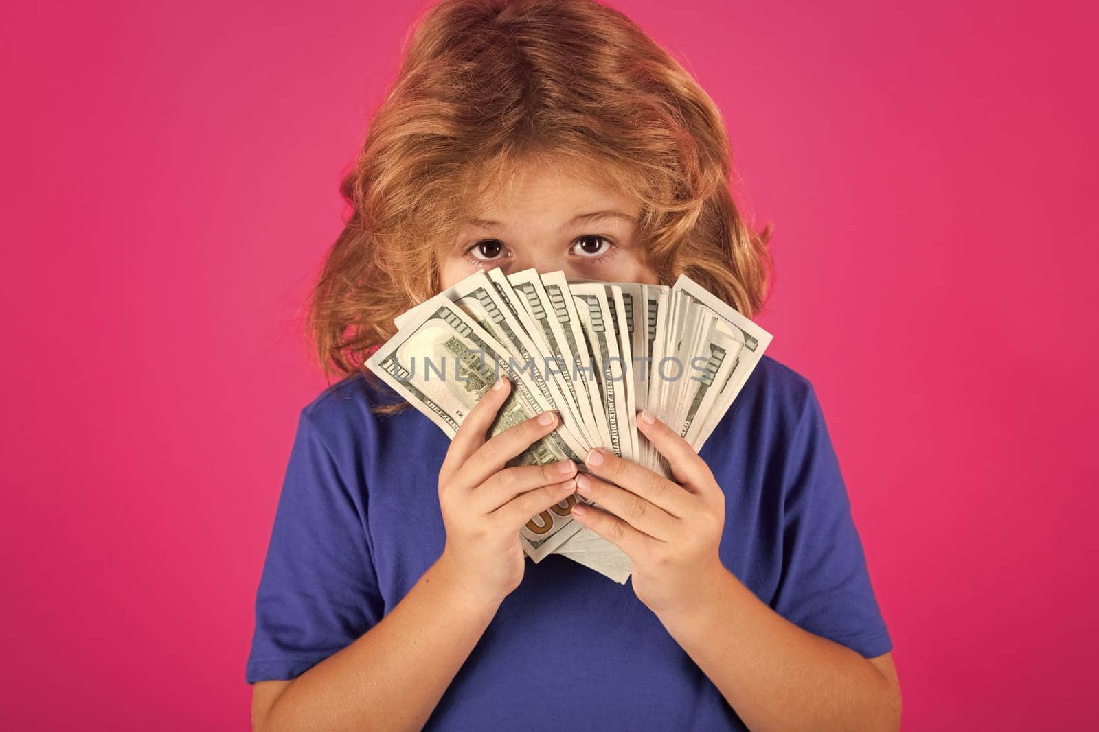 Rich kid with dollars. Lottery cashback, win big money isolated pink red background. 100 American dollars banknotes