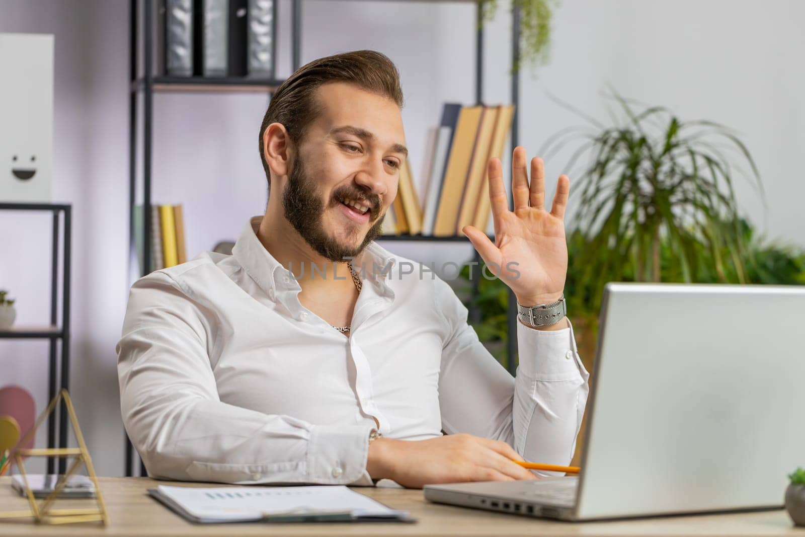 Businessman working on laptop computer at office desk talk on online communication video call with employee. Manager man boss support services looking at webcam of computer