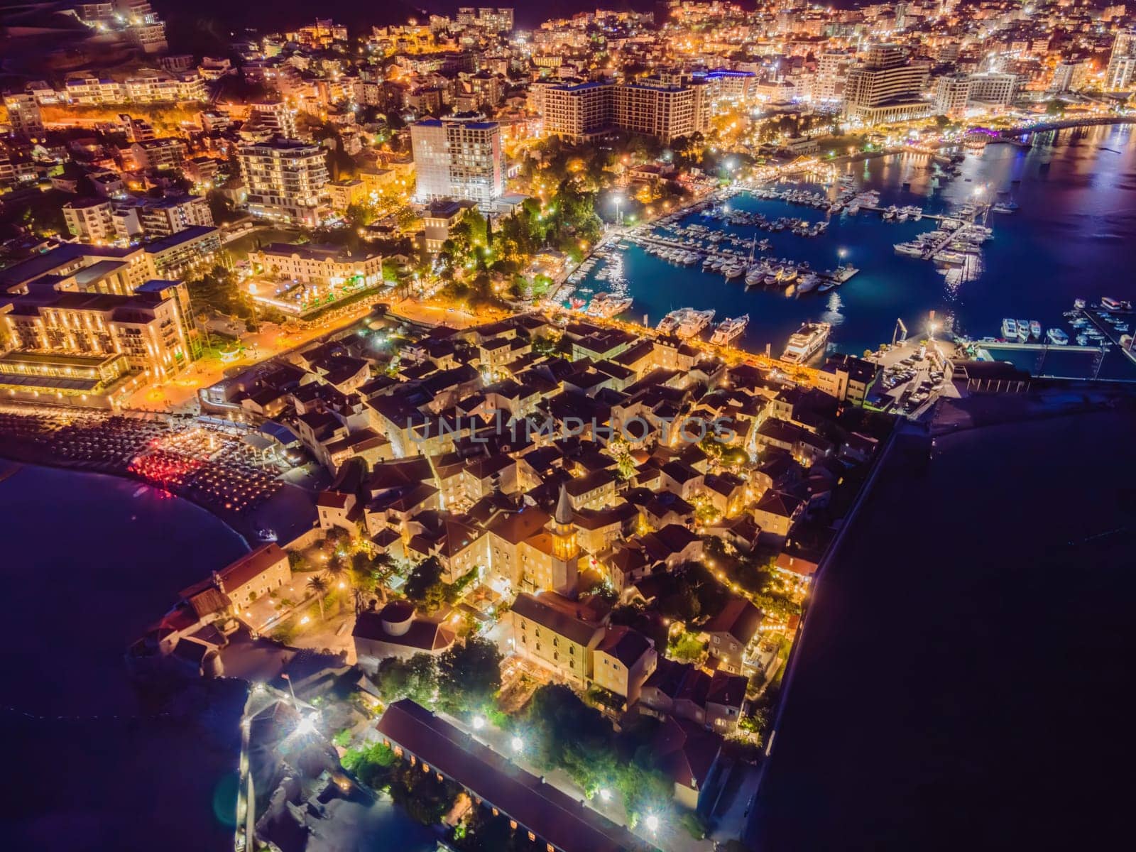 Budva city lights from Montenegro seen from above. Night view. Drone old town Budva at night by galitskaya
