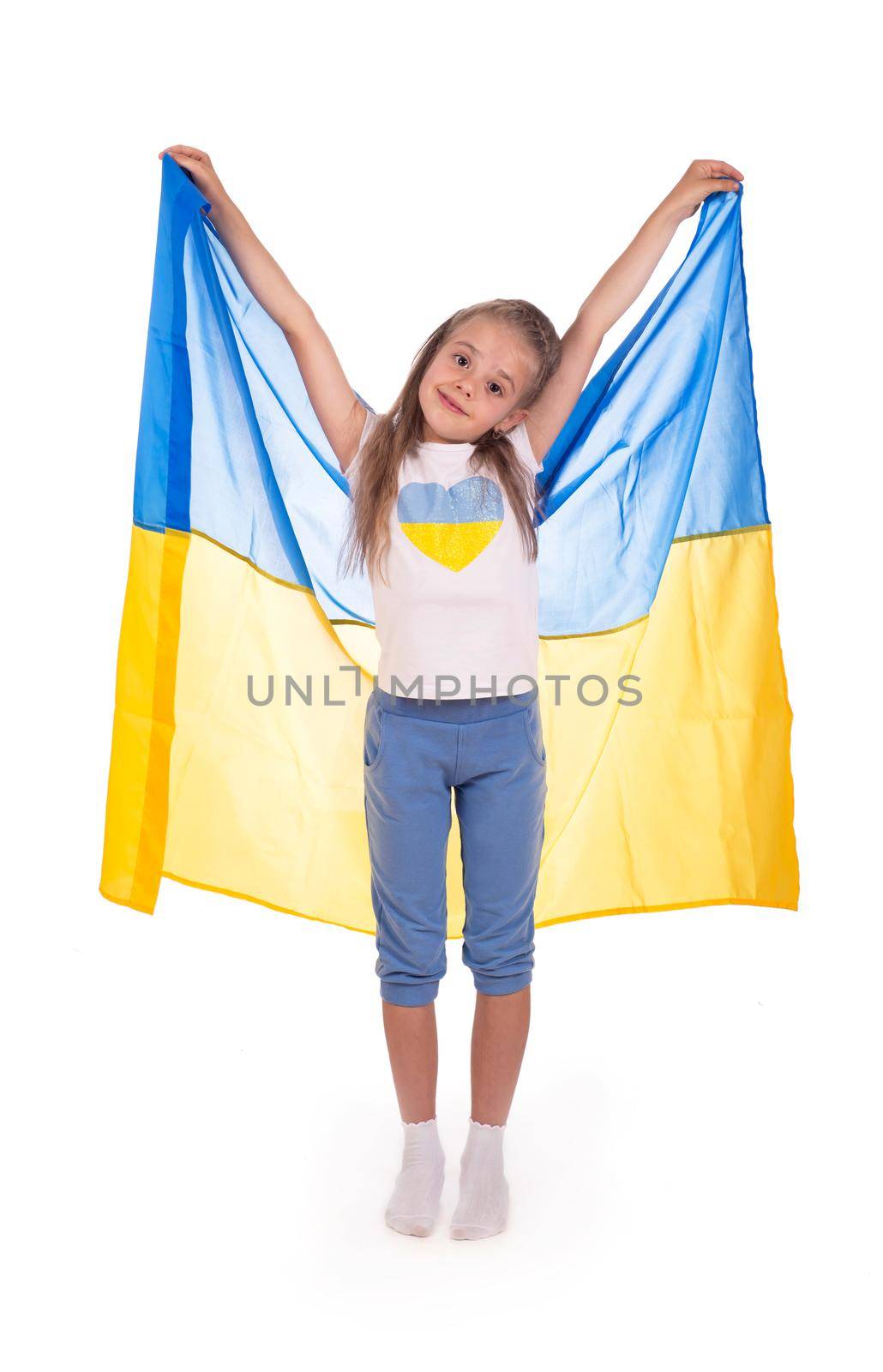 Happy young white girl holding Ukraine flag isolated on a white background