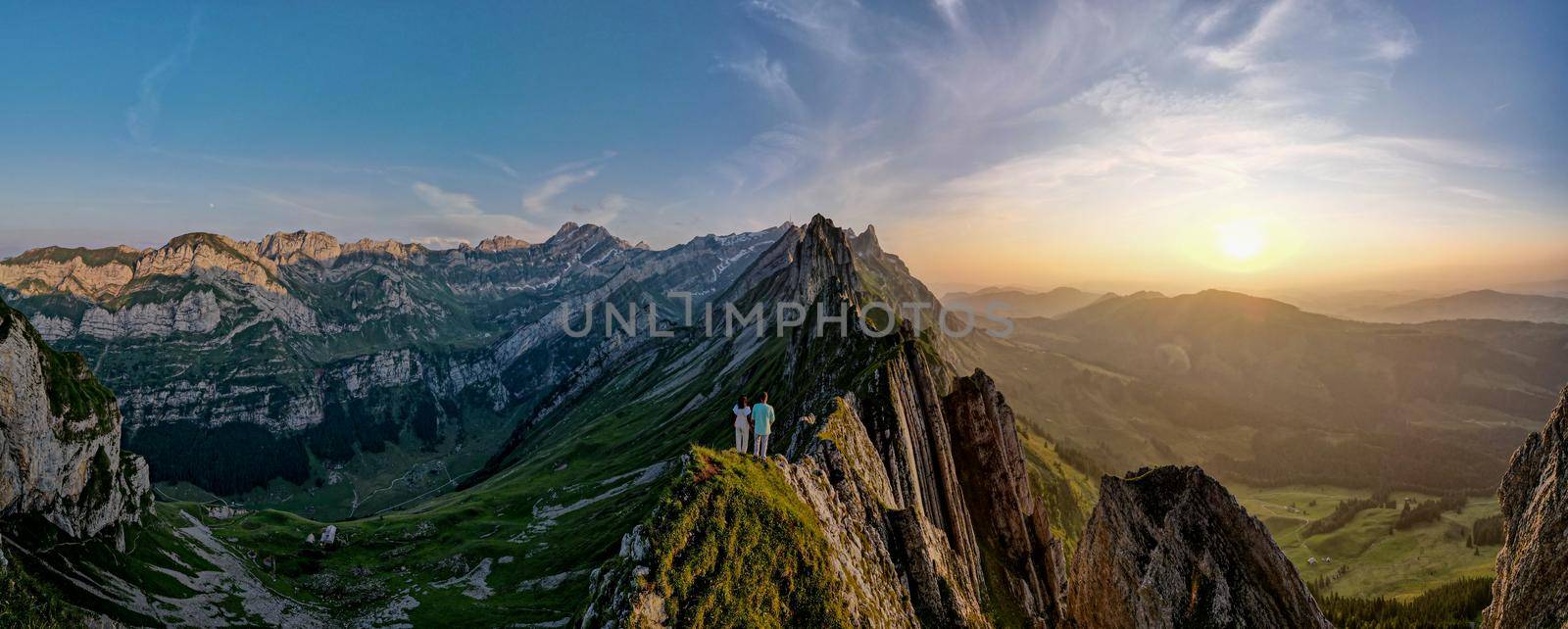 Schaefler mountain ridge swiss Alpstein, Appenzell Switzerland, steep ridge of the majestic Schaefler peak, Switzerland. couple man and woman mid age in the mountains, man and woman hiking 