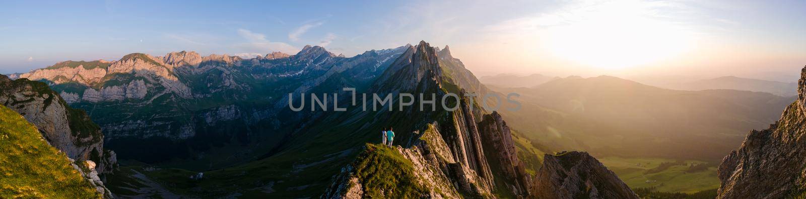 Schaefler mountain ridge swiss Alpstein, Appenzell Switzerland, steep ridge of the majestic Schaefler peak, Switzerland. couple man and woman mid age in the mountains, man and woman hiking 