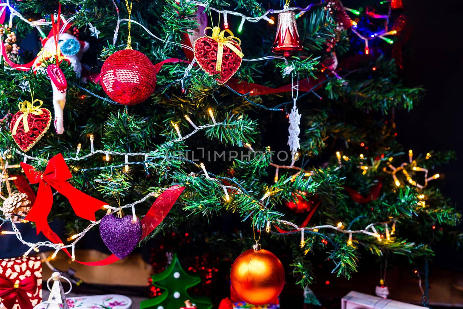 Christmas hanging decorations on fir tree. Decorated Christmas tree. Fir branch with Christmas baubles decorations.