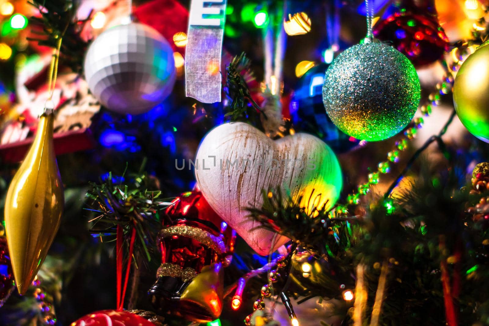 Beautiful Christmas ornaments and lights hanging in the Christmas tree by vladispas