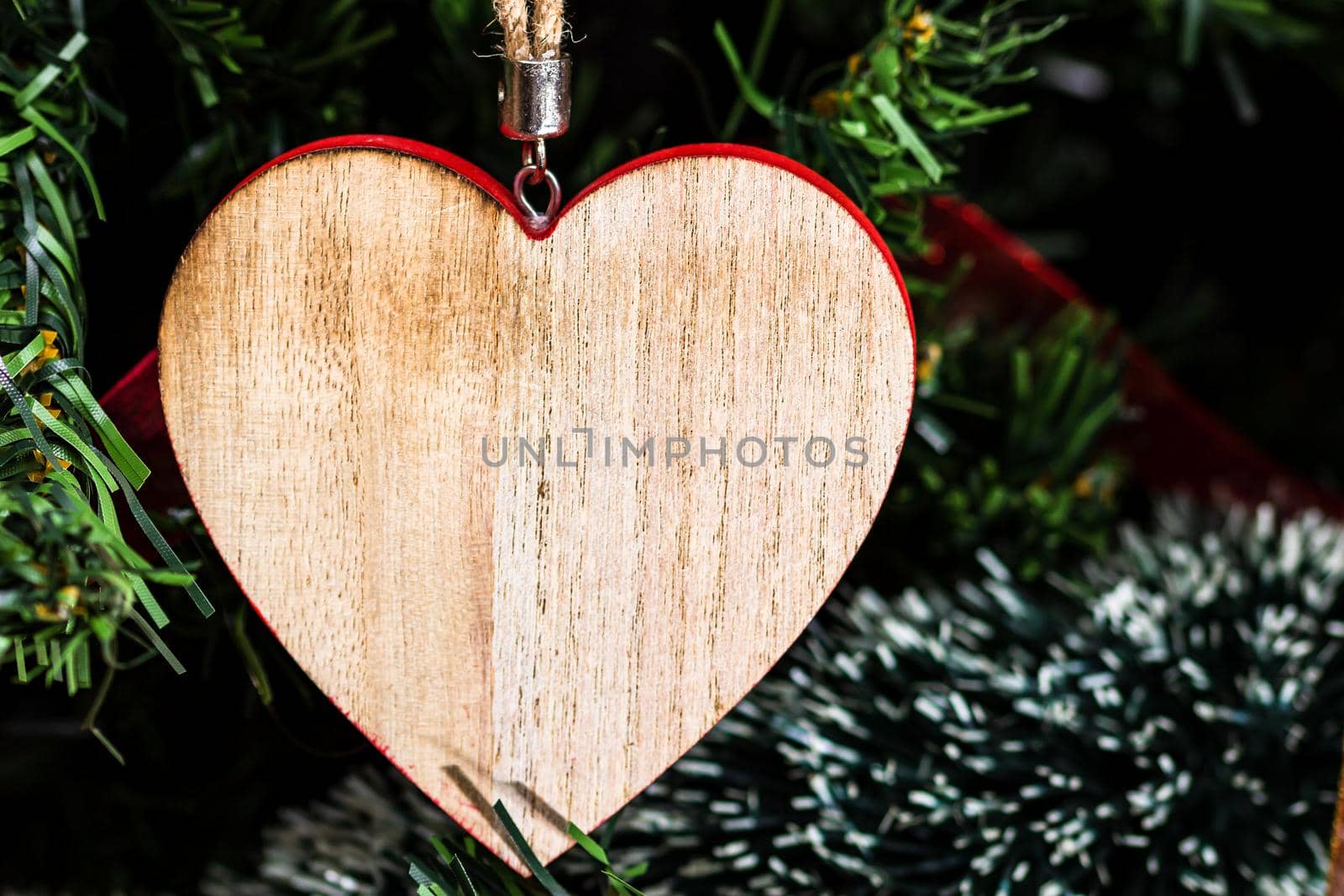 Heart shaped Christmas ornament hanging in the Christmas tree