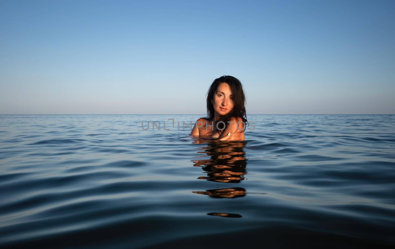 woman swims in the sea by palinchak