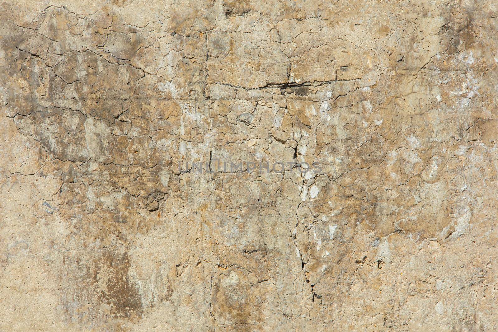 cracked white concrete wall under direct sun light full frame background and seamless texture.