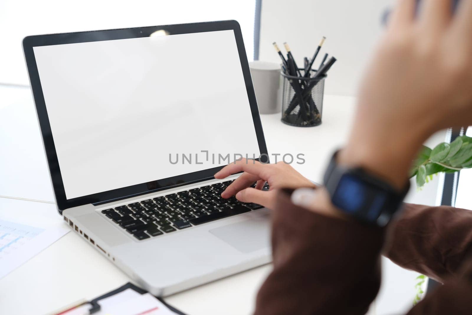 Cropped shot of creative woman hand typing on laptop computer, working on design project at office.