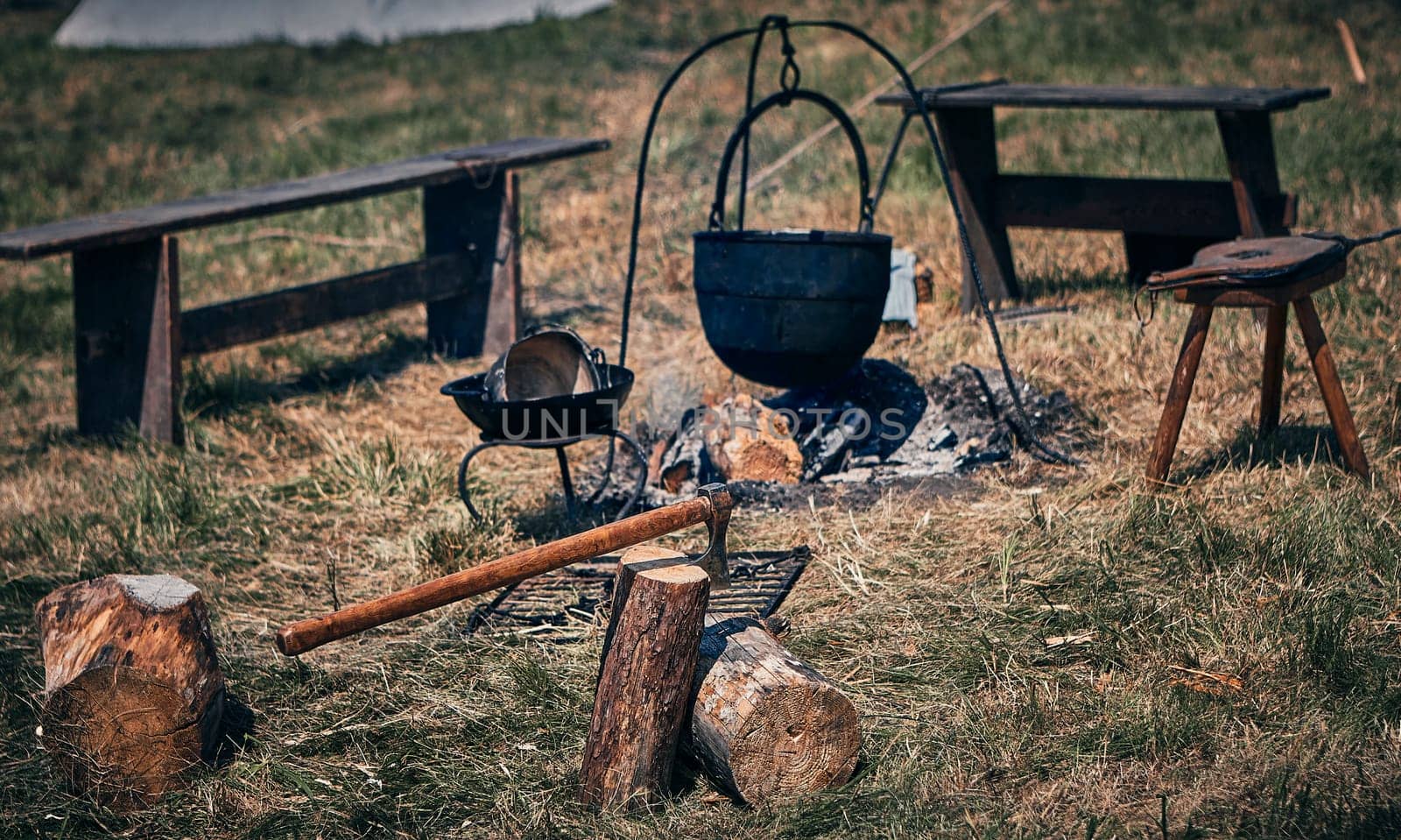 Camping. Soup in a pot over a fire. Stylization under the Middle Ages, vintage.