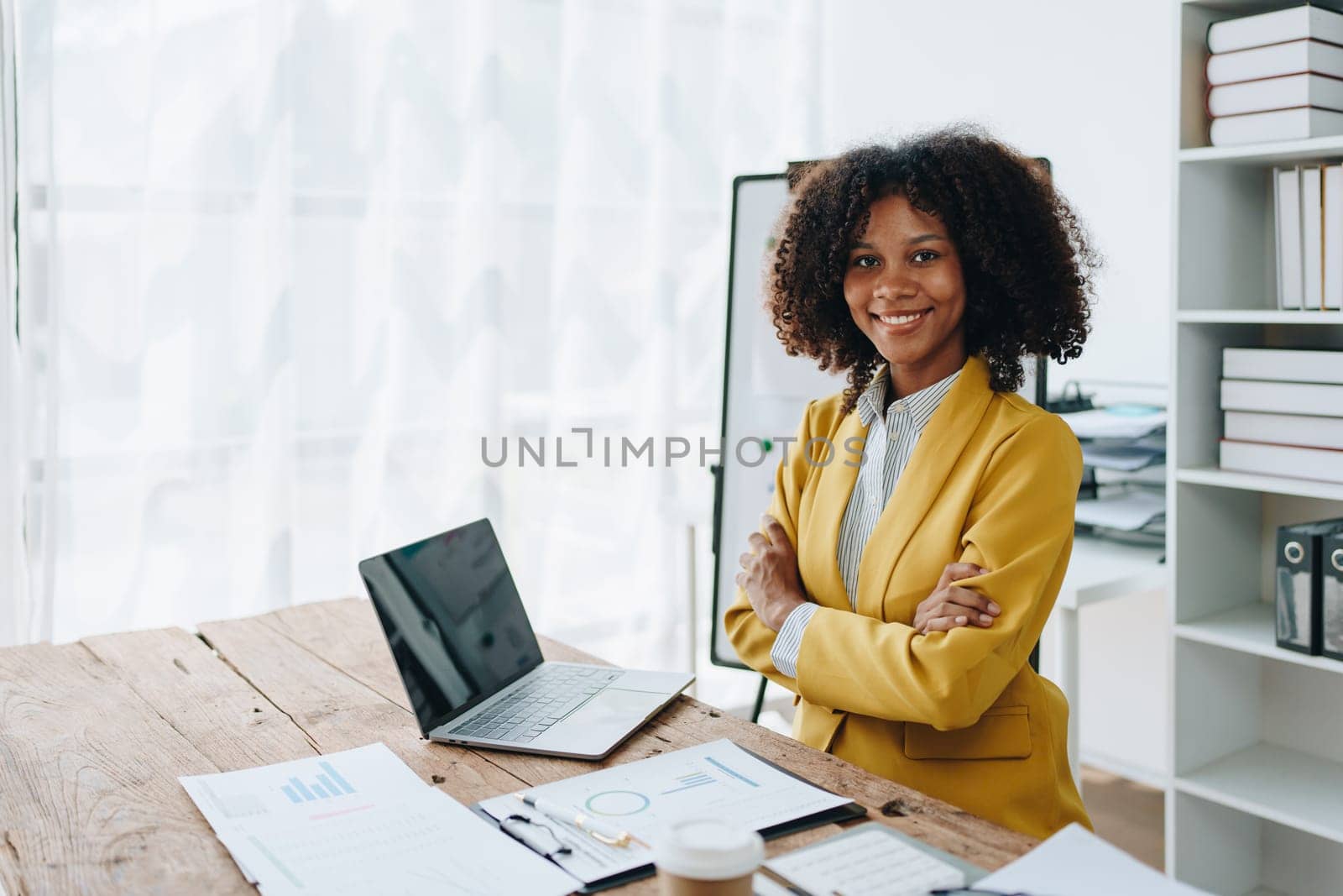 American African business woman using document, computer laptop, calculator, paperwork, documents, in winner and smiling Happy to be successful achievement success. finance and investment concepts by Manastrong