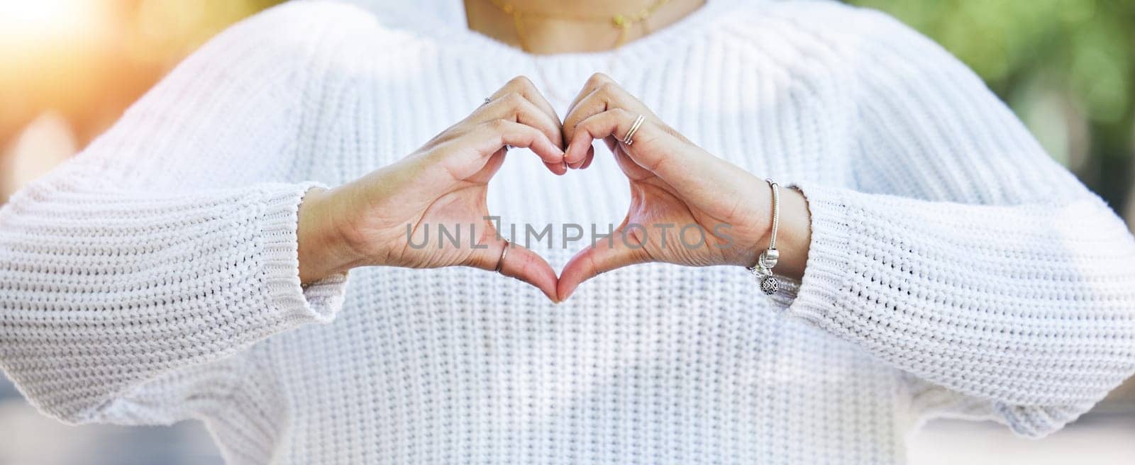 Love, heart and peace with hands of woman in nature for support, motivation and kindness. Thank you, lens flare and hope with closeup of person and sign in outdoors for emoji, health and banner.