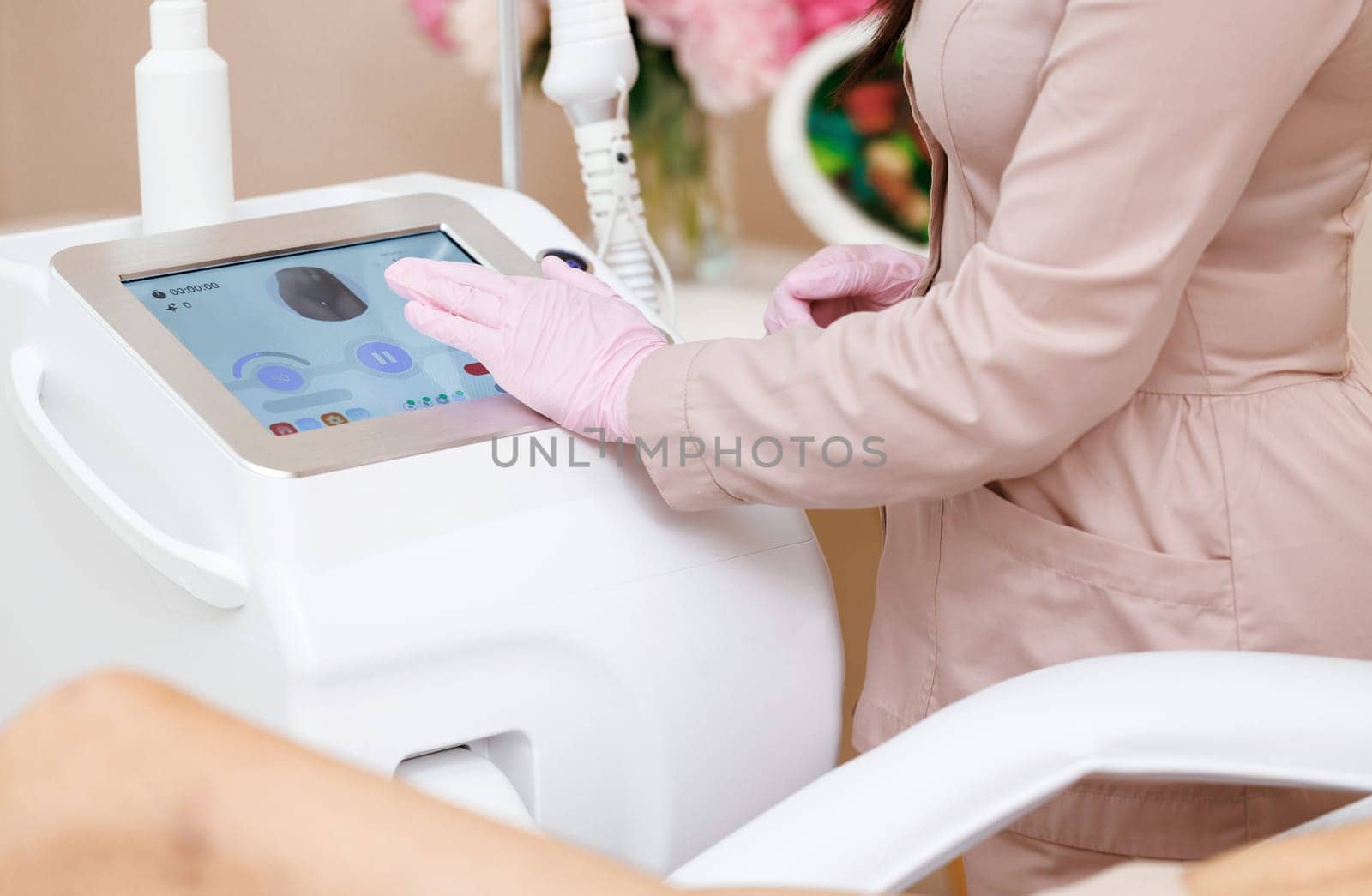 Esthetician preparing equipment for epilation procedure. Hands of beautician hold the laser device for an epilation or laser epilator. Laser hair removal, beauty, health care, beauty procedures. by uflypro