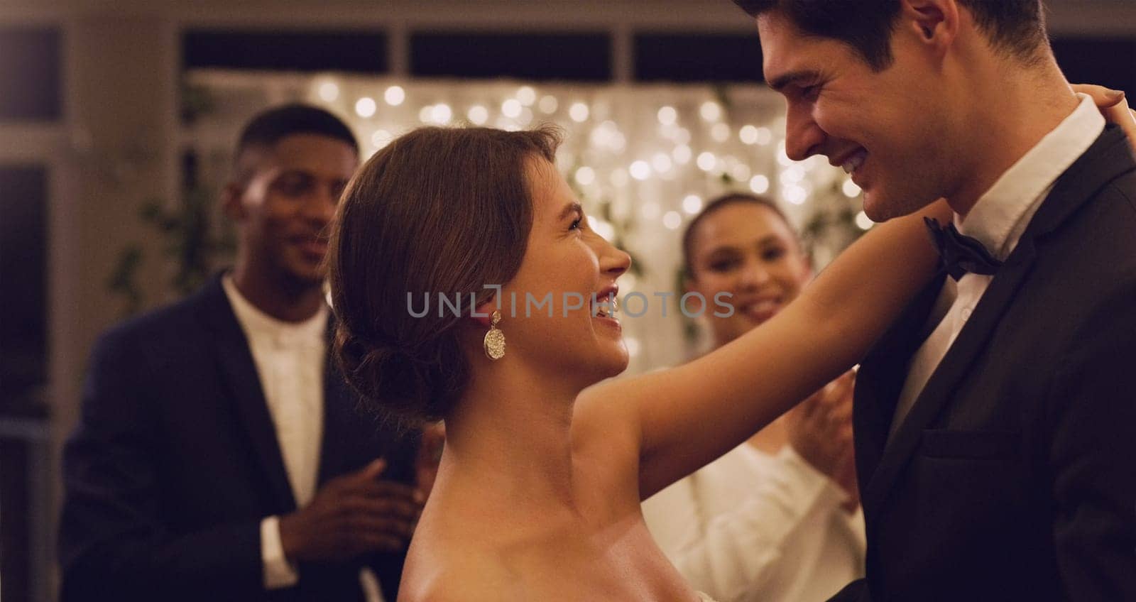 Im already loving being married to you. Cropped shot of an affectionate young newlywed couple dancing in front of their guests at their wedding reception. by YuriArcurs