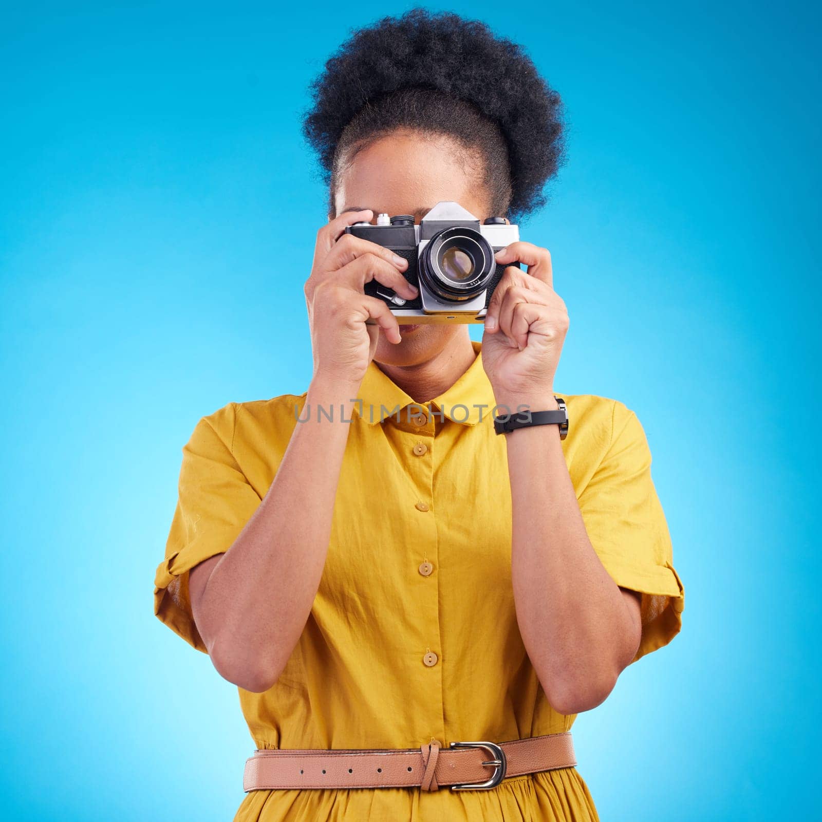Photography, travel and black woman with camera isolated on blue background, creative artist job and talent. Art, face of photographer with hobby or career in studio taking picture for photoshoot