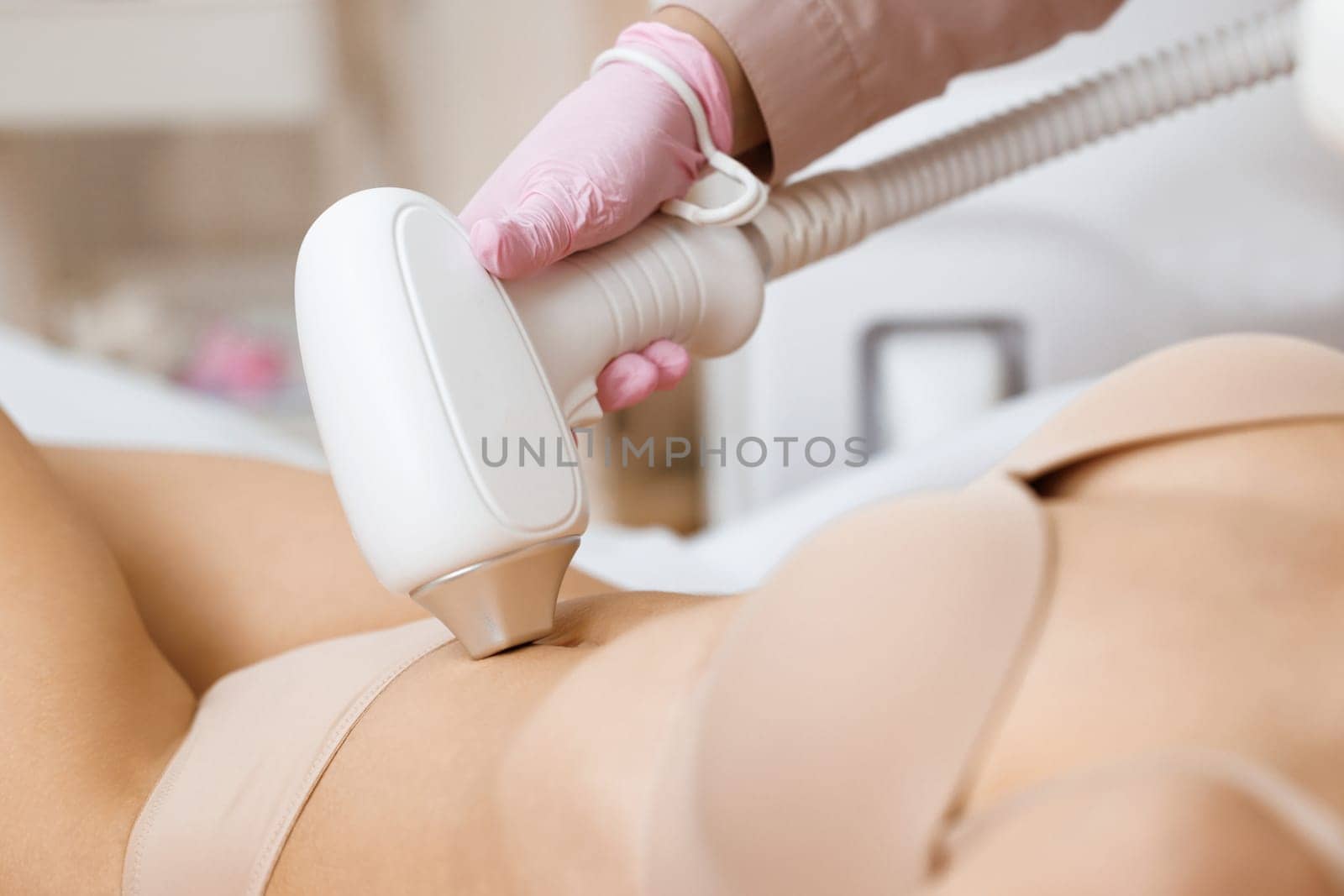 Laser in aesthetic medicine. Epilation. Woman on laser hair removal treatments thighs and bikini area. Beautician removes hair on bikini zone, using a laser. Receiving laser epilation on bikini zone. by uflypro