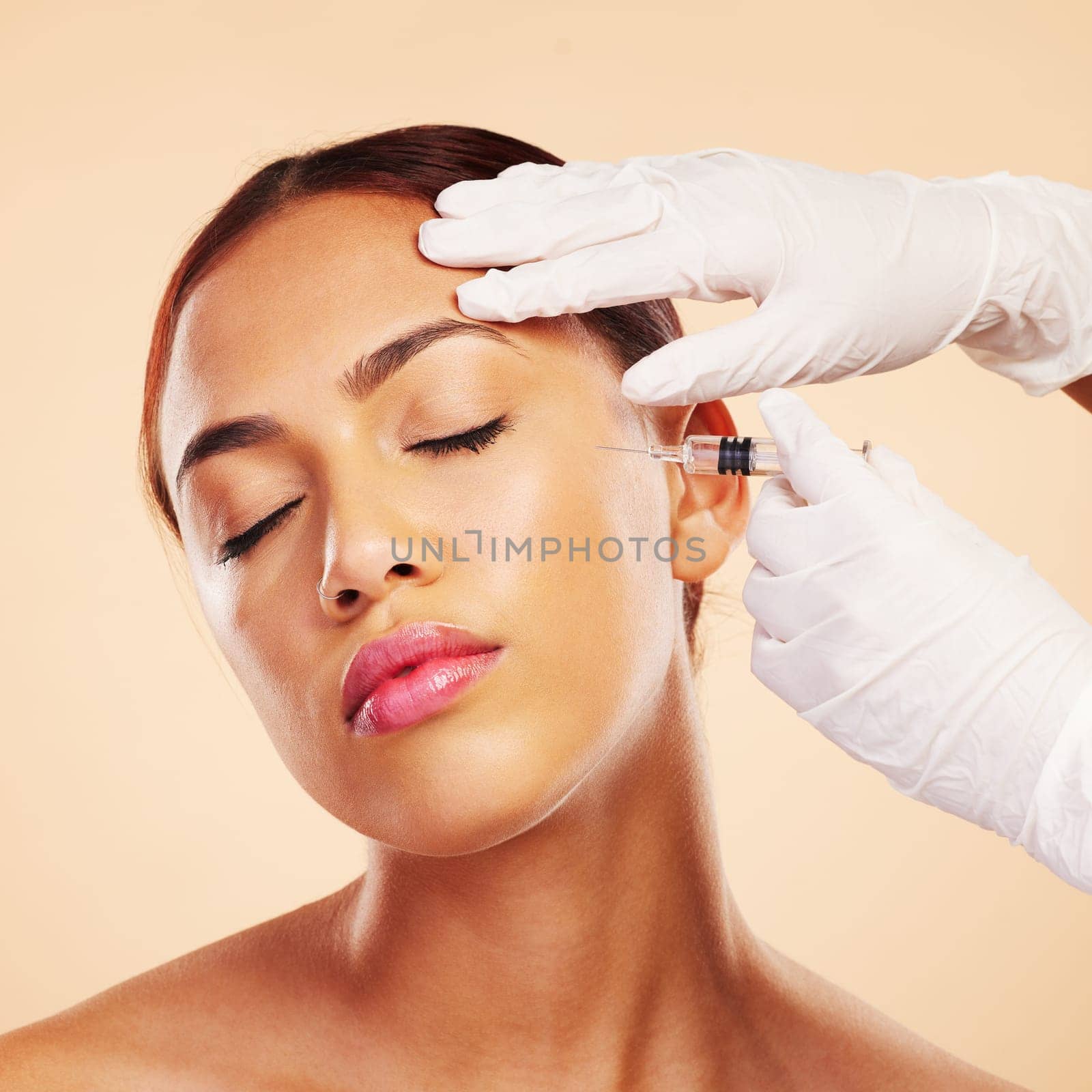 Hands, woman or plastic surgery with needle for facelift or cosmetics isolated on studio background. Cheek, anti aging or girl model with injection, dermatology and beauty glow in medical procedure.