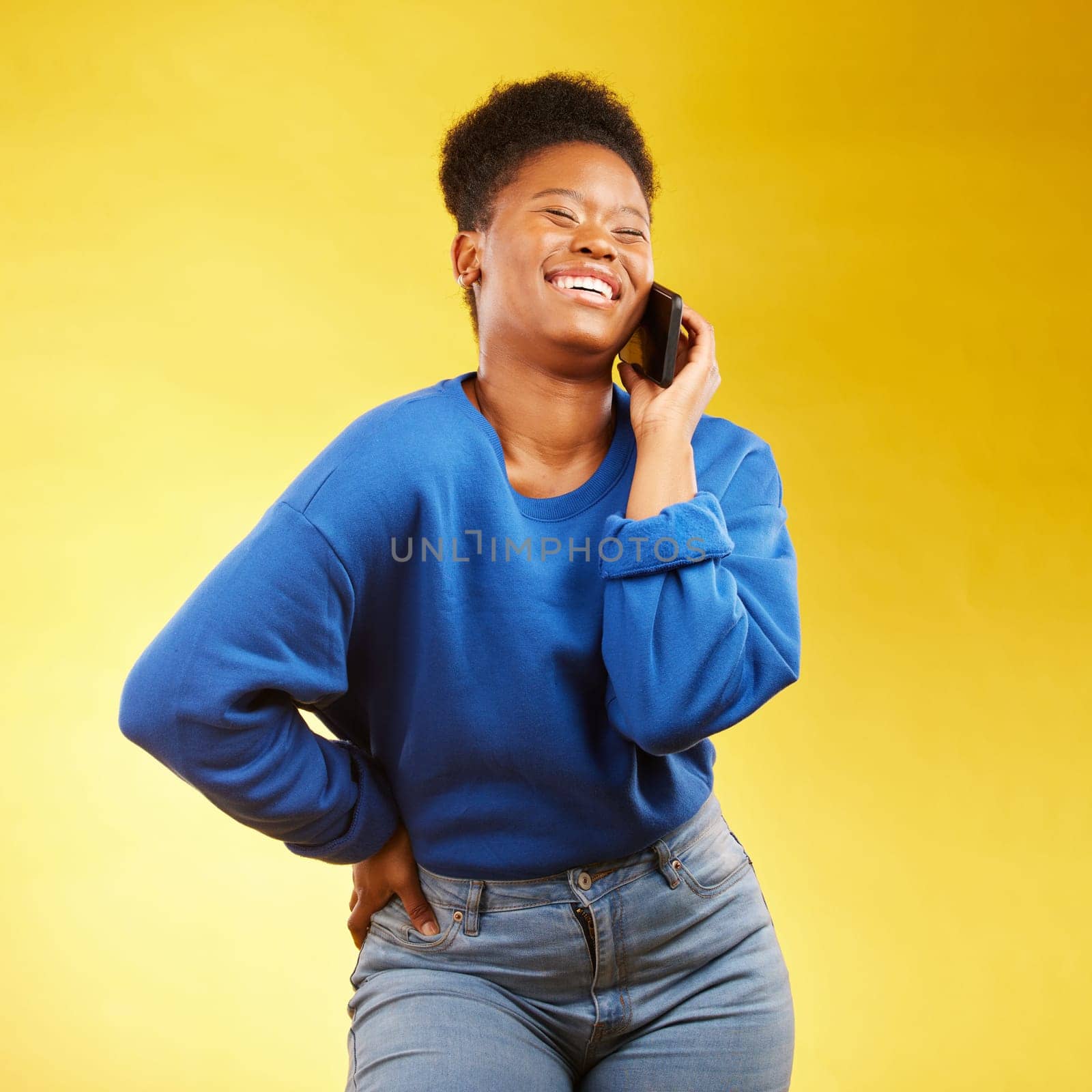 Phone call, laugh and black woman in studio happy, silly or share joke on yellow background. Funny, talking and African lady with goofy, gossip or conversation on smartphone for online communication.