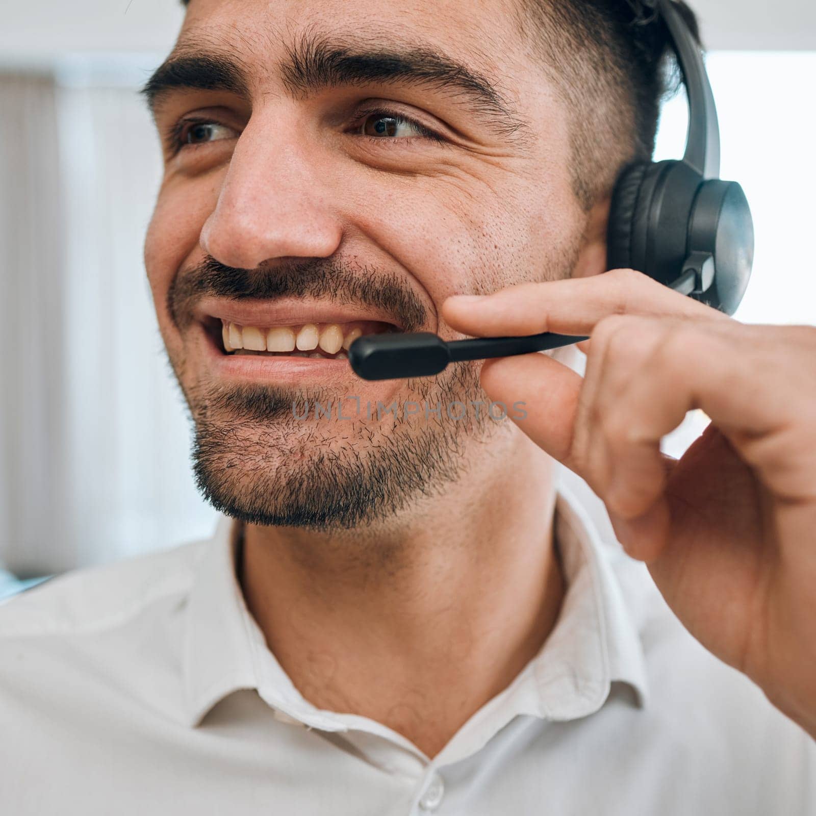 Telemarketing, man or face of happy consultant for customer service, business support and CRM advisor. Salesman, agent and smile with microphone at call center, telecom communication or FAQ questions.