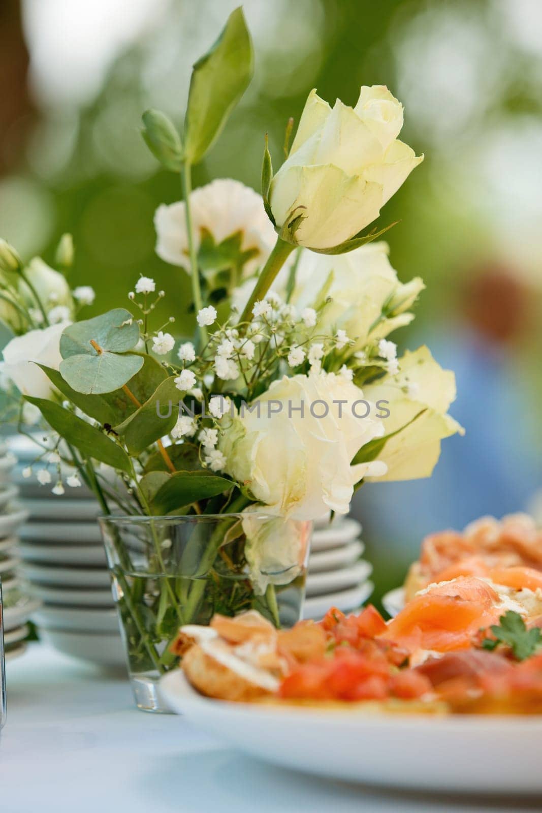 Composition of fresh flowers on a festive wedding table. Elegance wedding decor. Selective focus.