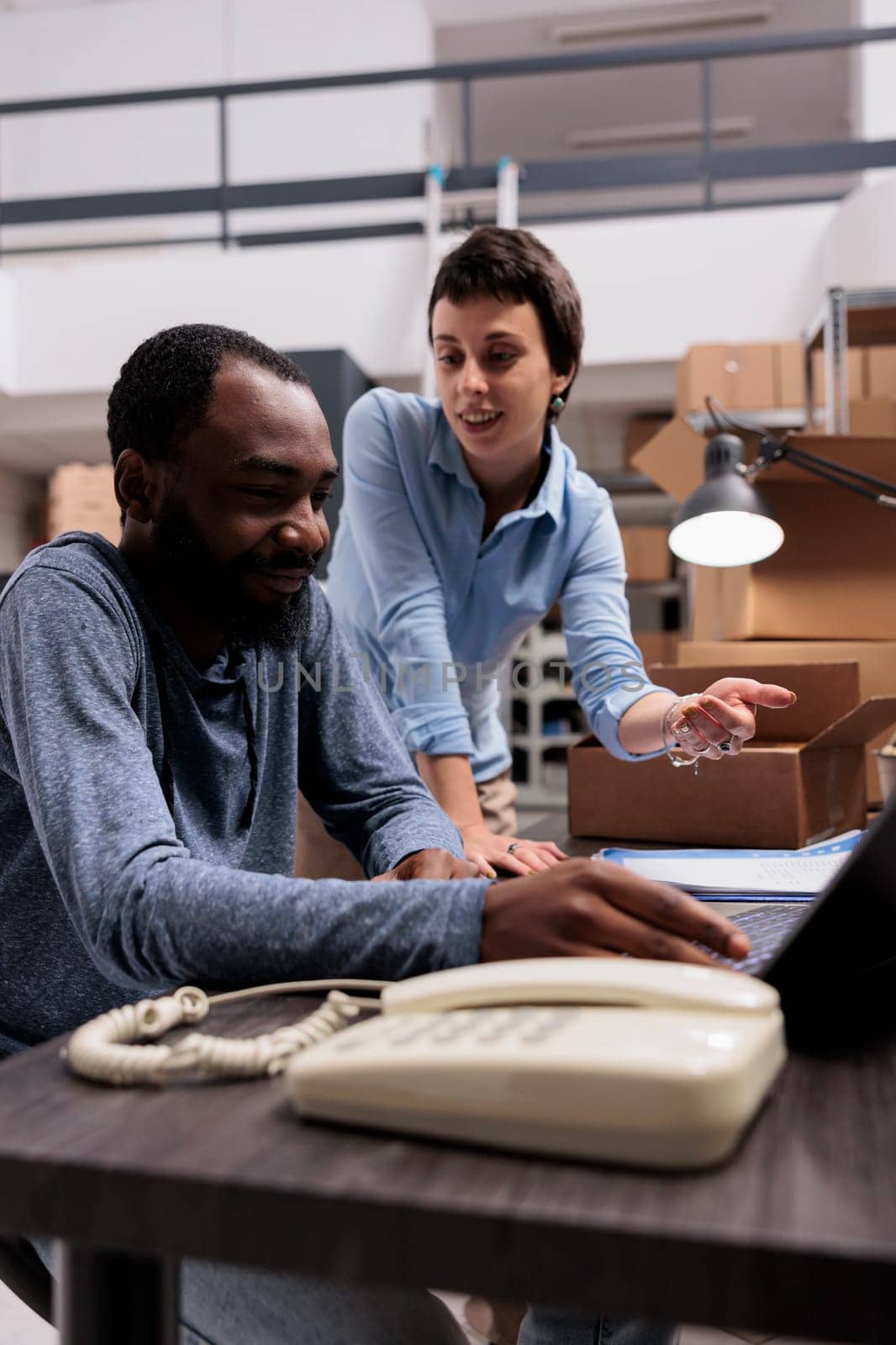 Manager and supervisor looking at cargo stock analyzing transportation logistics on laptop computer by DCStudio