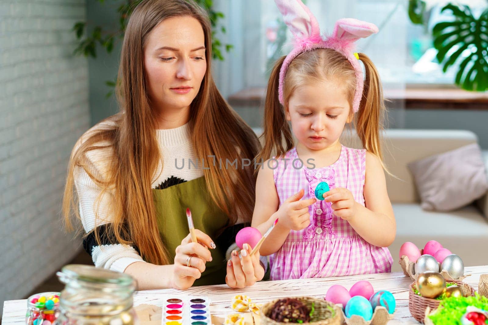 Cute family, mother and daughter preparing for Easter celebration by Fabrikasimf