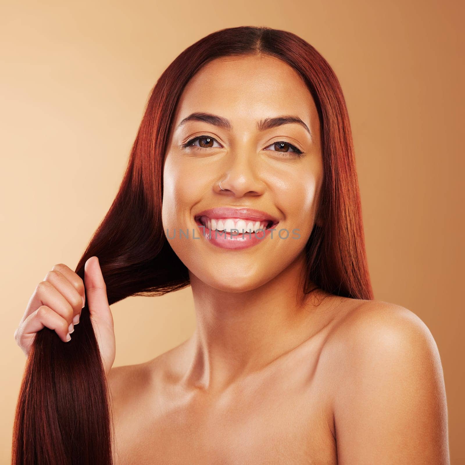 Haircare, beauty and portrait of happy woman with strong hair in hand, glow and luxury salon treatment on brown background. Keratin, haircut and smile, face of model in cosmetics and makeup in studio by YuriArcurs
