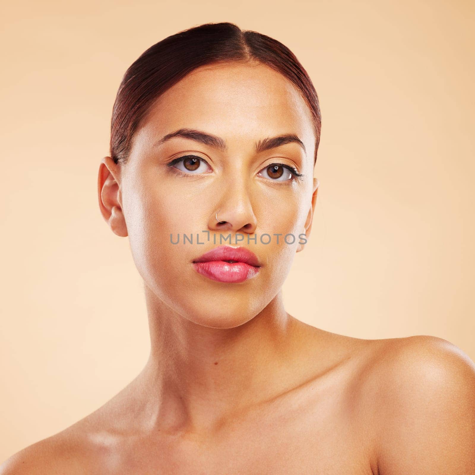 Portrait, skincare and woman with beauty, dermatology and makeup against a brown studio background. Face, female person and model with wellness, aesthetic or cosmetics with health, glow and shine by YuriArcurs