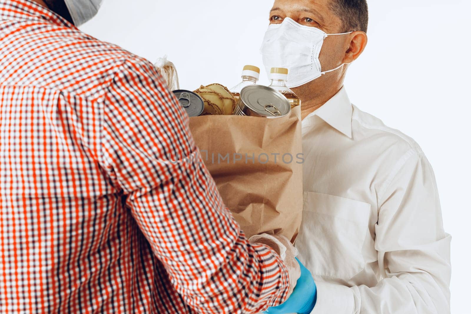 Delivery man in face mask and gloves. Food delivery, online shopping concept while coronavirus pandemia worldwide