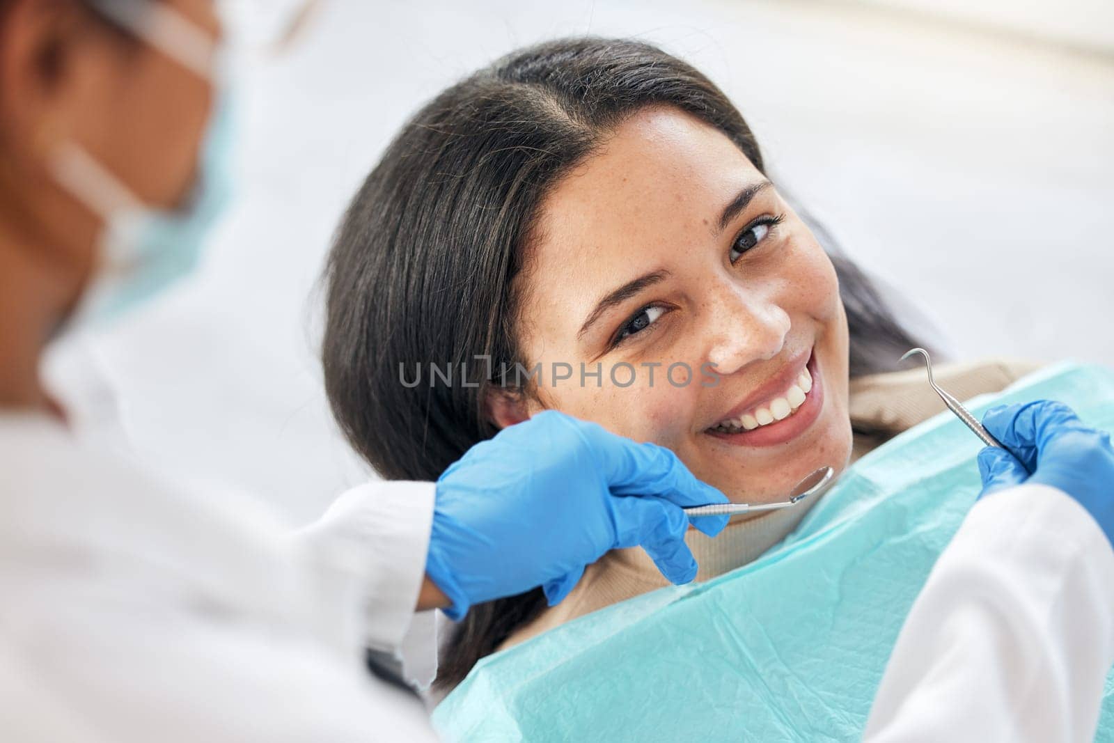 Dentist, dental care and teeth smile of a woman with tools and hands of a professional by mouth. Portrait of a female patient for orthodontics, healthcare and cleaning or inspection for oral health.