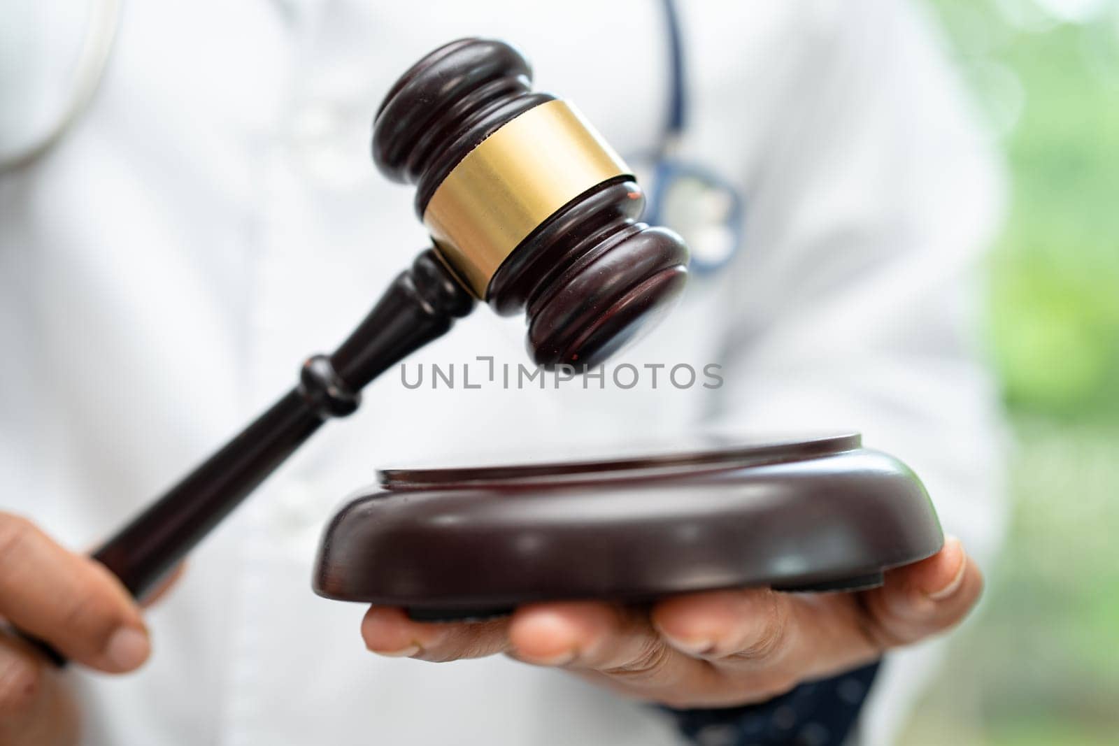 Doctor holding judge gavel, forensic medicine, medical law and crime justice concept. by pamai