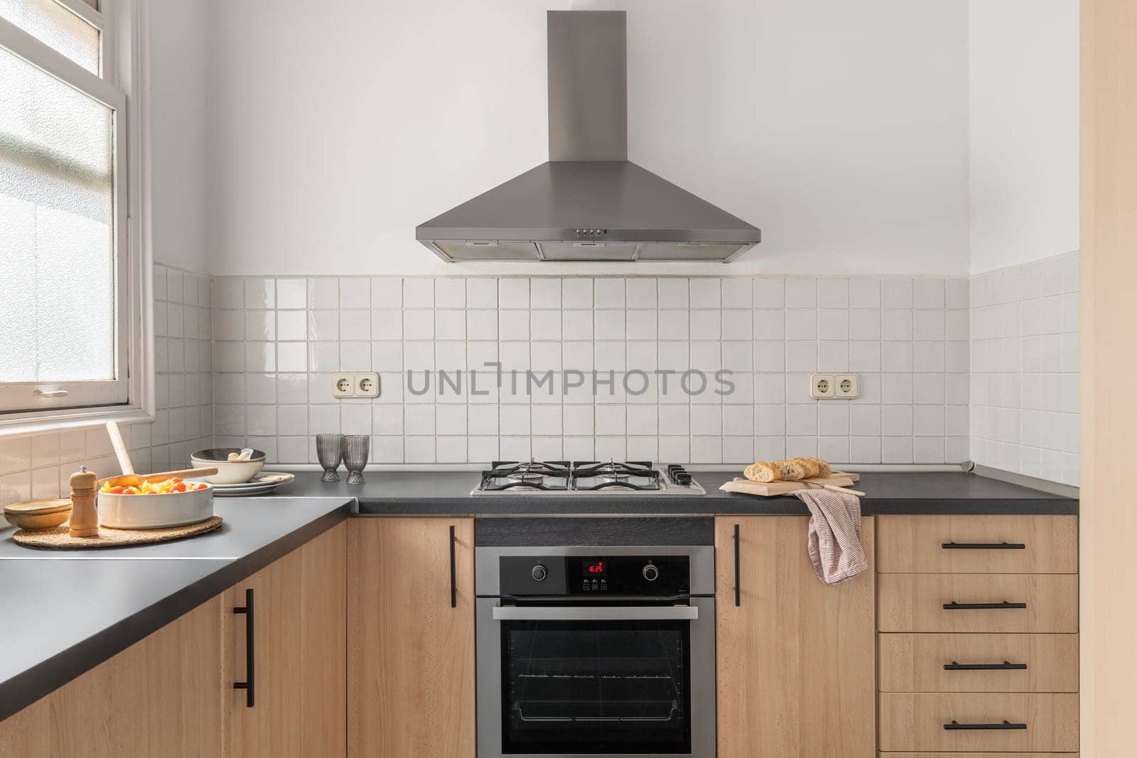 Bright clean kitchen with contemporary design, modern cabinetry, gas stove oven, sink, and ample storage for utensils and cookware. Ideal for culinary exploration home showcase interior.