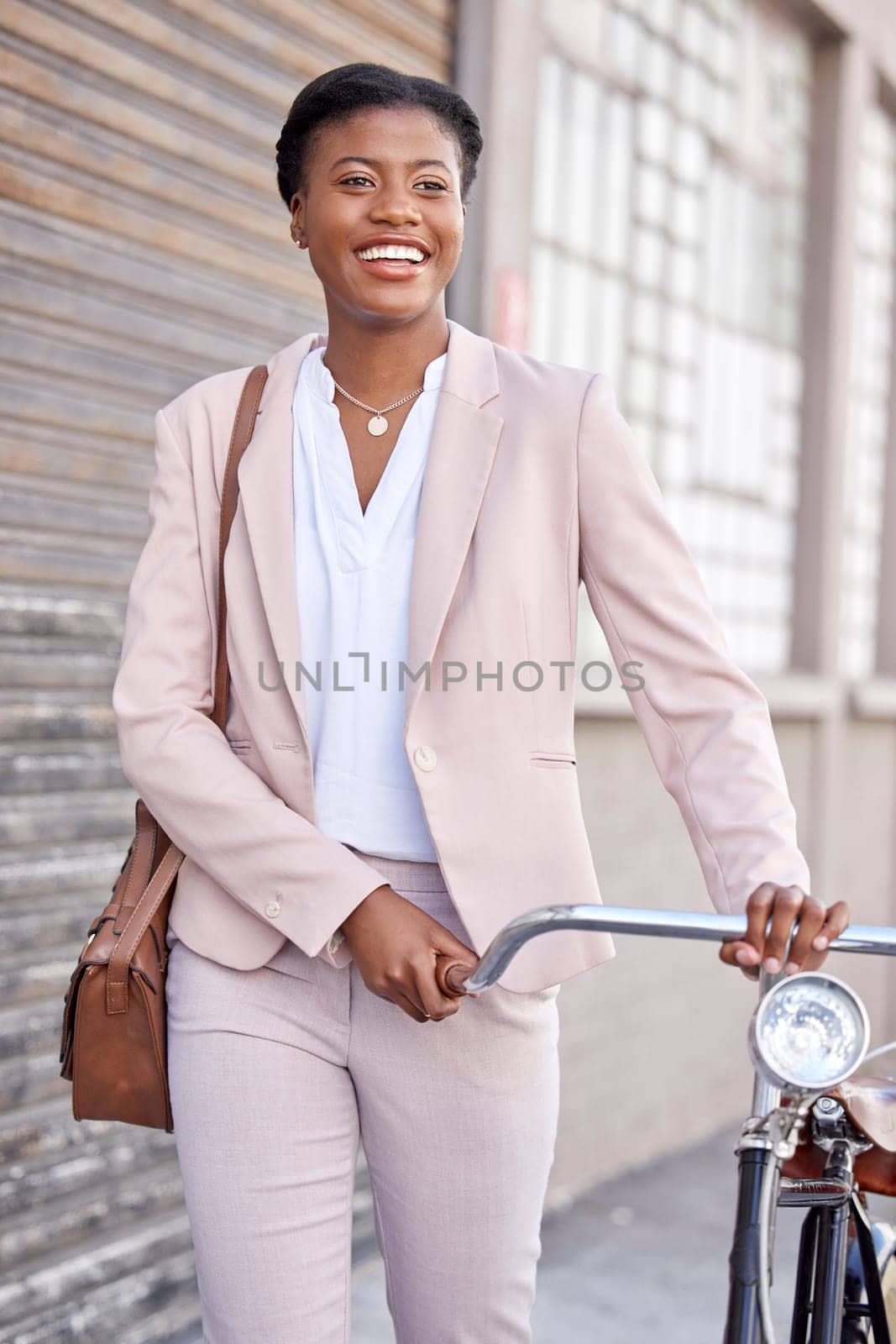 Business woman in city with bicycle, smile and sustainable morning commute walking on sidewalk. Eco friendly transport bike, cycling and happy African girl with urban transportation on work travel. by YuriArcurs