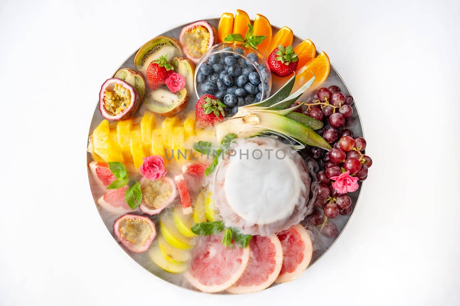 Raw fruits berries assortment platter on the plate, on the white table by bizzyb0y