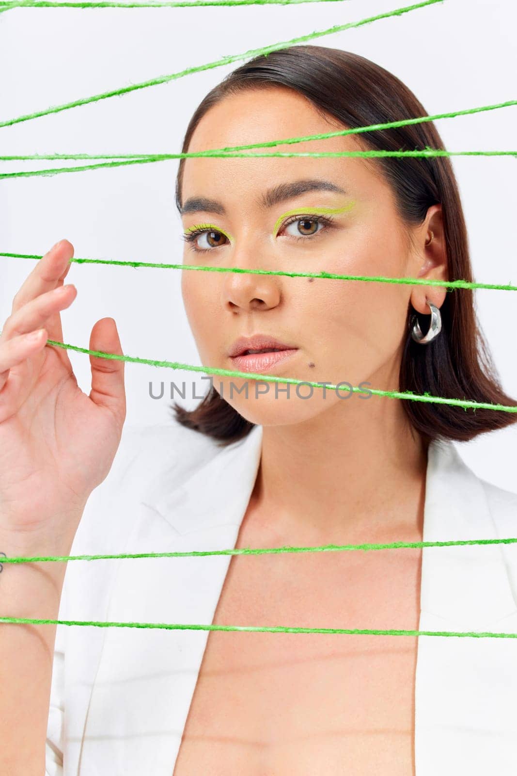 Creative, fashion and string with portrait of woman in studio for makeup, art and cosmetics. Abstract, cotton and texture with face of asian model on white background for designer, trendy and textile.