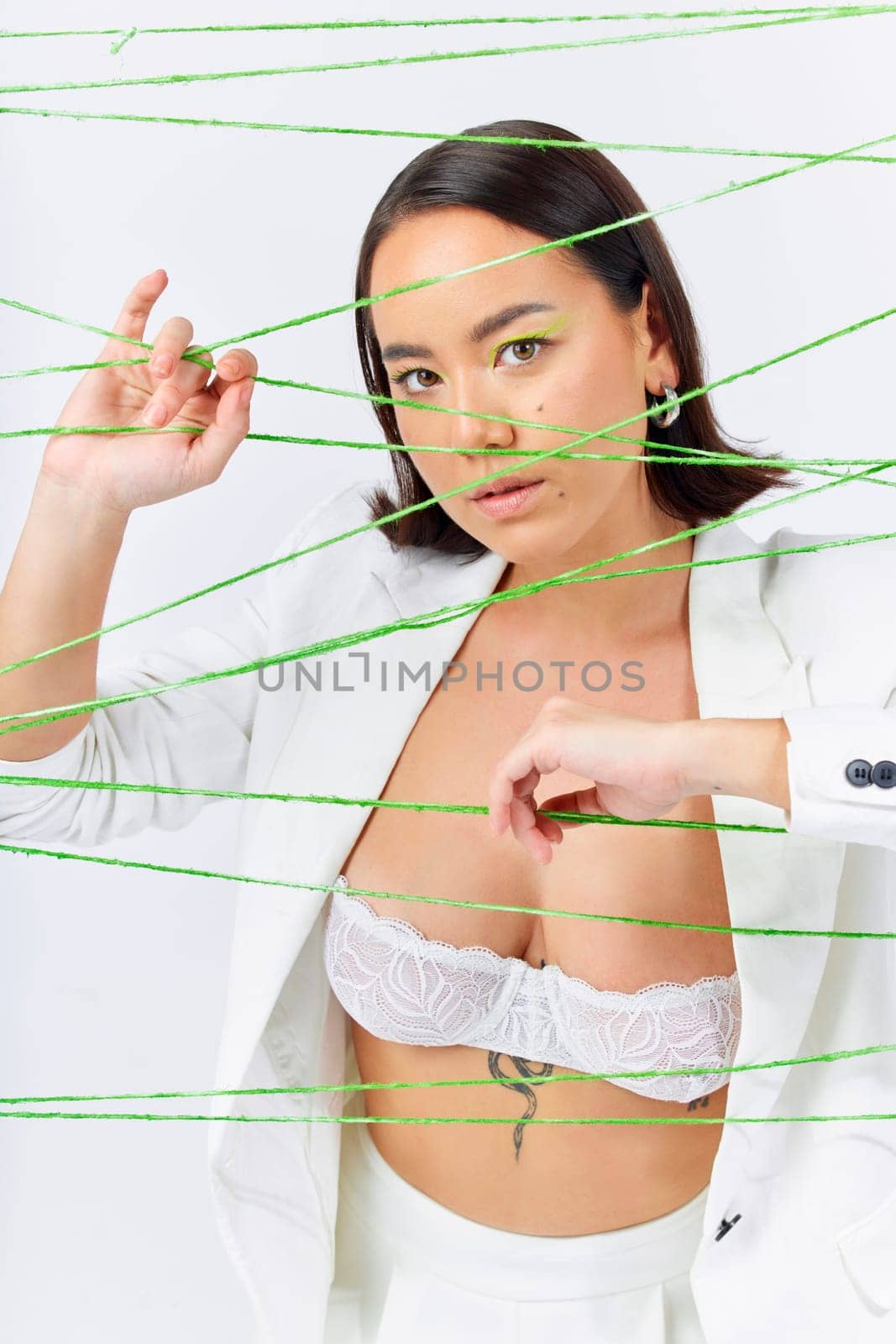 Art, fashion and strings with portrait of Asian woman in studio for creative makeup and cosmetics. Abstract, cotton and texture with face of model on white background for designer, trendy and textile.