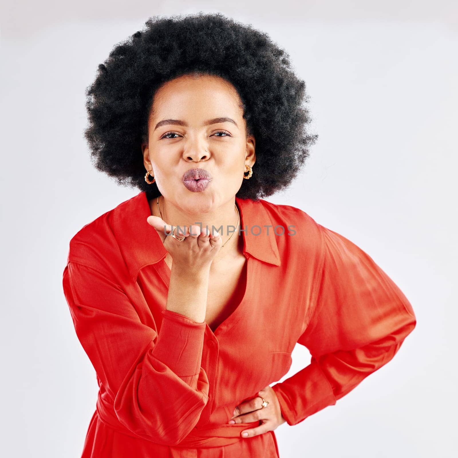 Happy, black woman and blowing a kiss for portrait of love, care and flirting in studio on white background. Emoji, kisses and face of girl with happiness, freedom and support for romantic gesture.