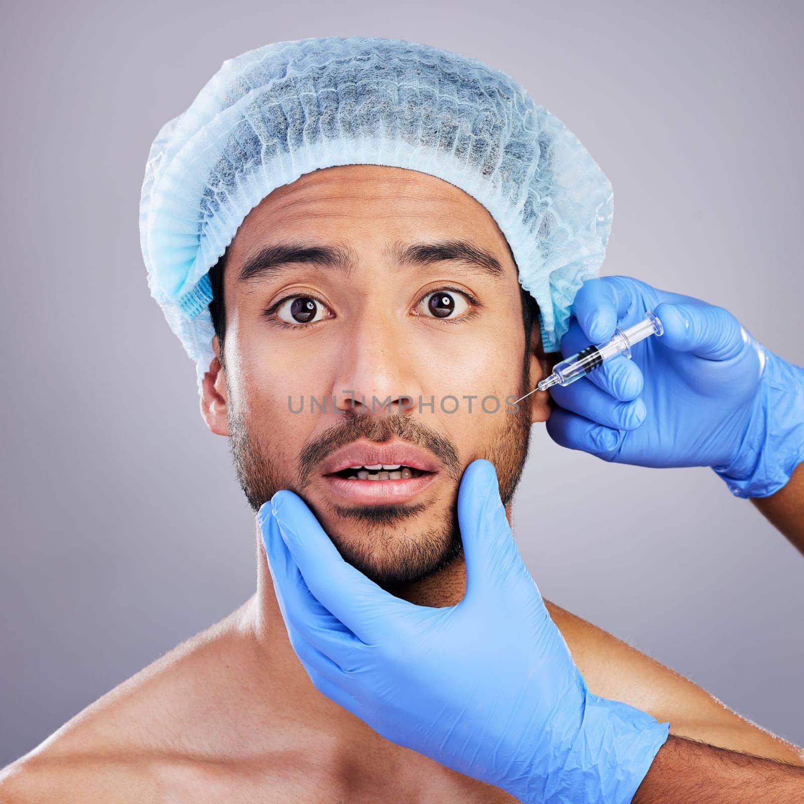 Hands, portrait and plastic surgery with a man in studio on a gray background for a botox injection. Face, beauty and transformation with a male customer in a clinic for antiaging filler or cosmetics.