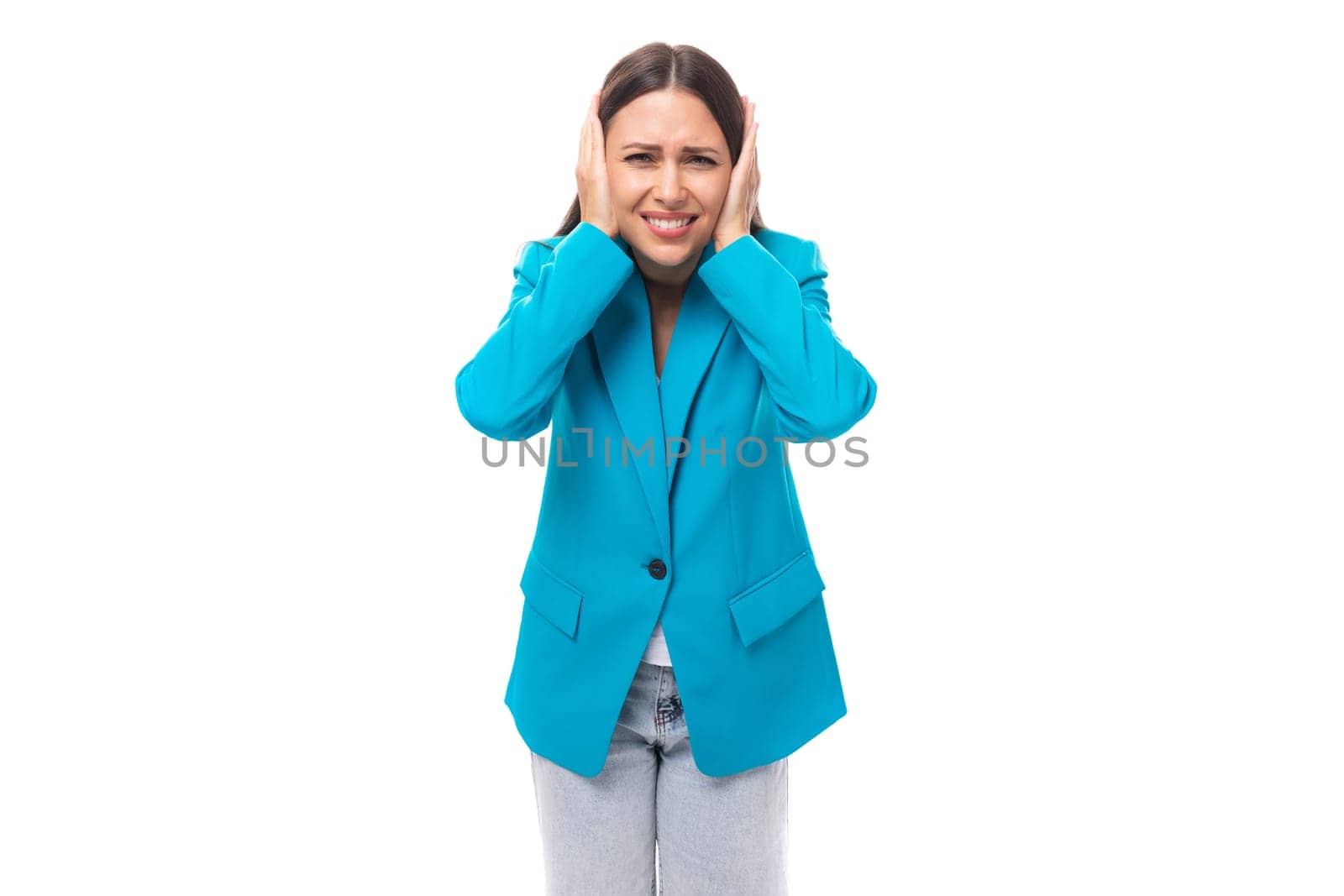 young indignant well-groomed office worker woman with black straight hair in a blue business jacket on a white background with copy space.