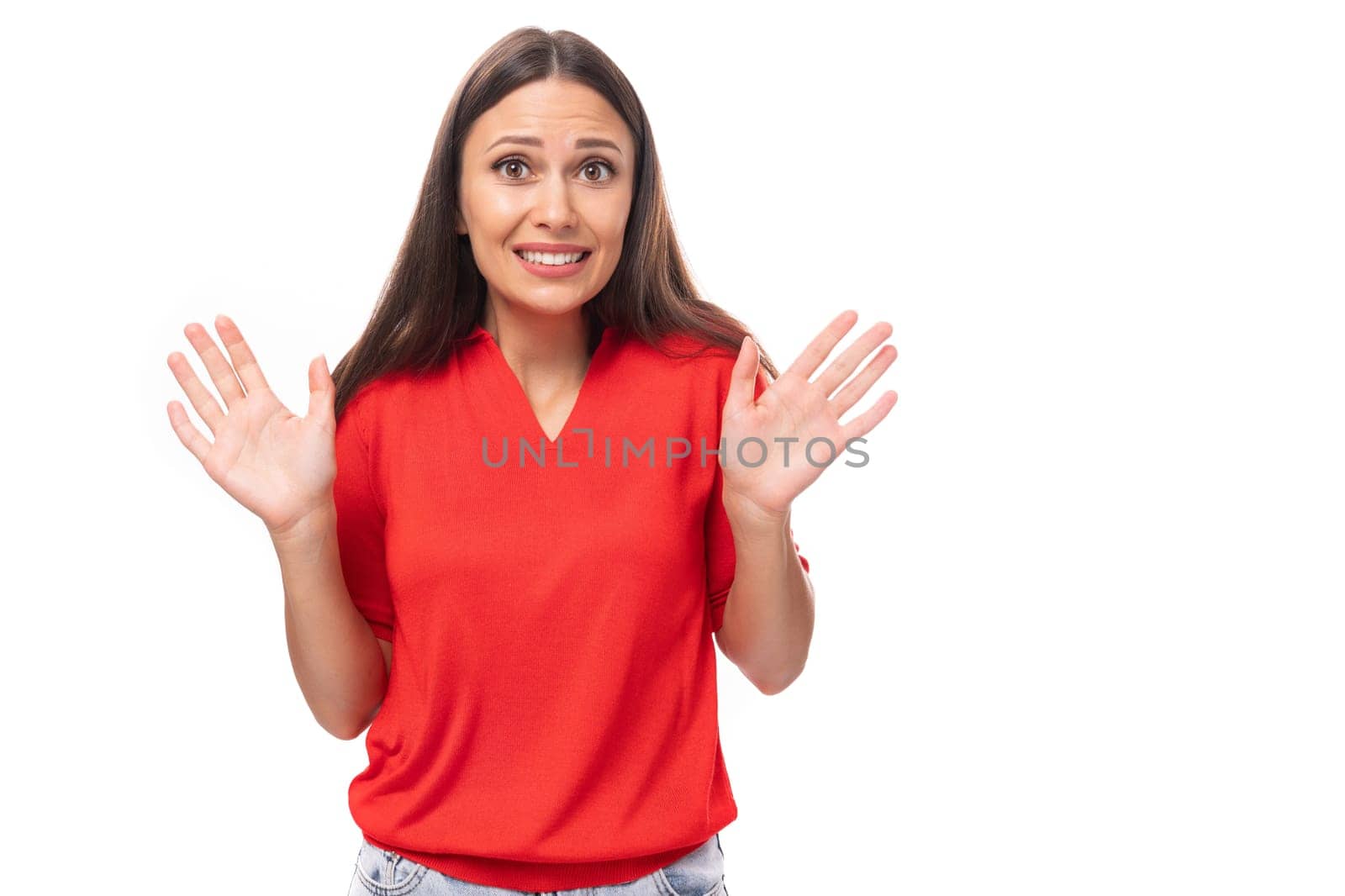 young attractive brunette woman in a red stylish v-neck blouse filled her arms in surprise.