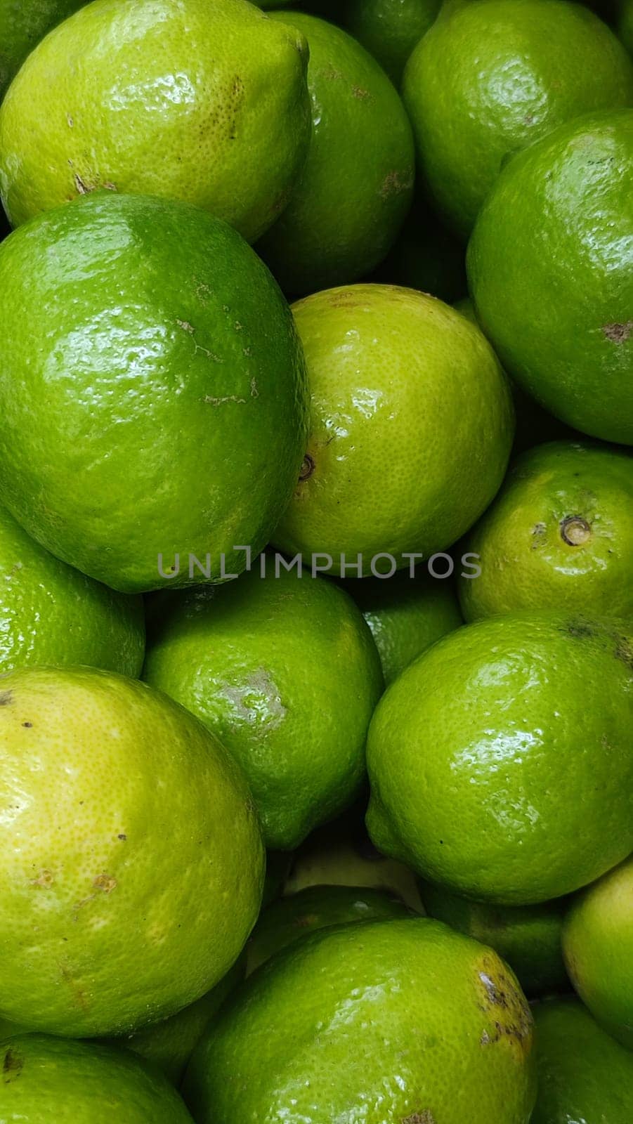 fresh green round lemons fruits summer food in the store, background. High quality photo