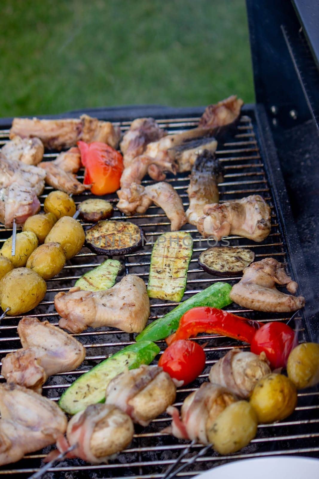 a man is grilling vegetables and meat. Selective focus. Nature