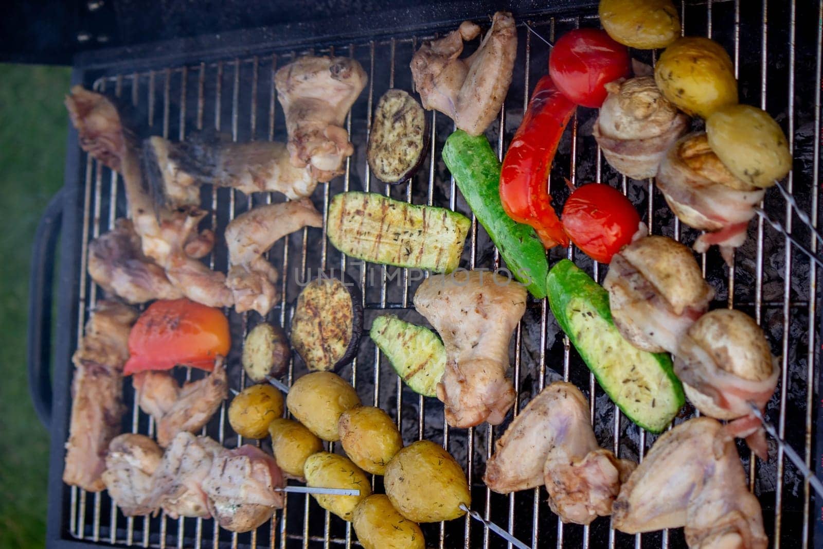 a man is grilling vegetables and meat. Selective focus. Nature