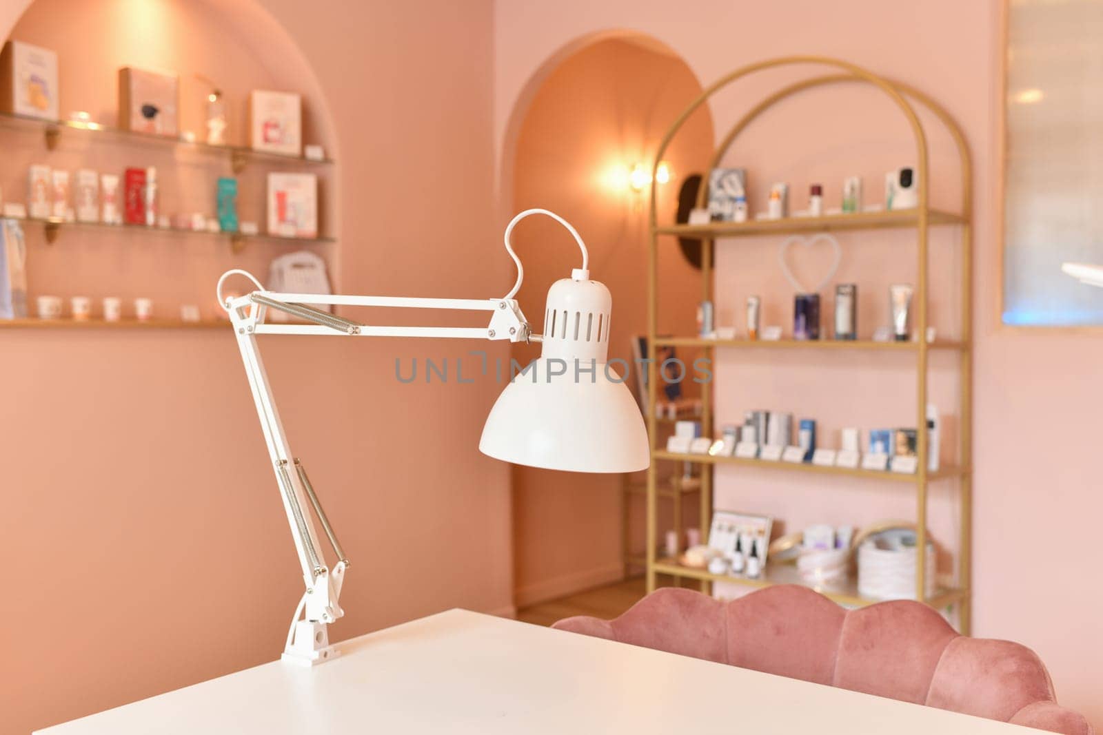 Nail salon with lamps and cozy chairs in the barbershop.